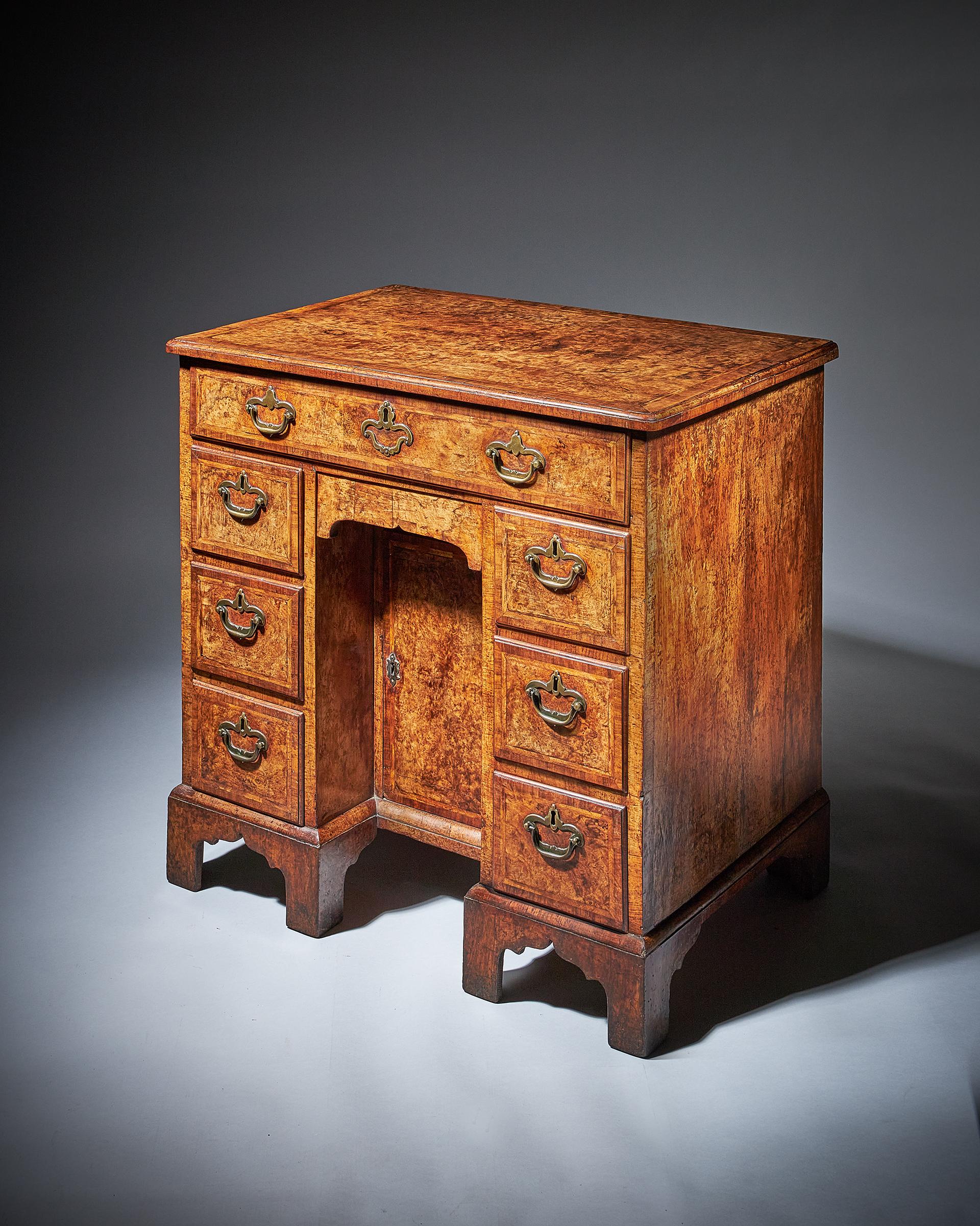 Rare Burr walnut George II 18th century kneehole desk / bachelor's chest, circa 1730-1740. England

The superb quarter veneered burr walnut top is bordered by a fine feather stringing, cross-banded and edged with cross-grain ovolo