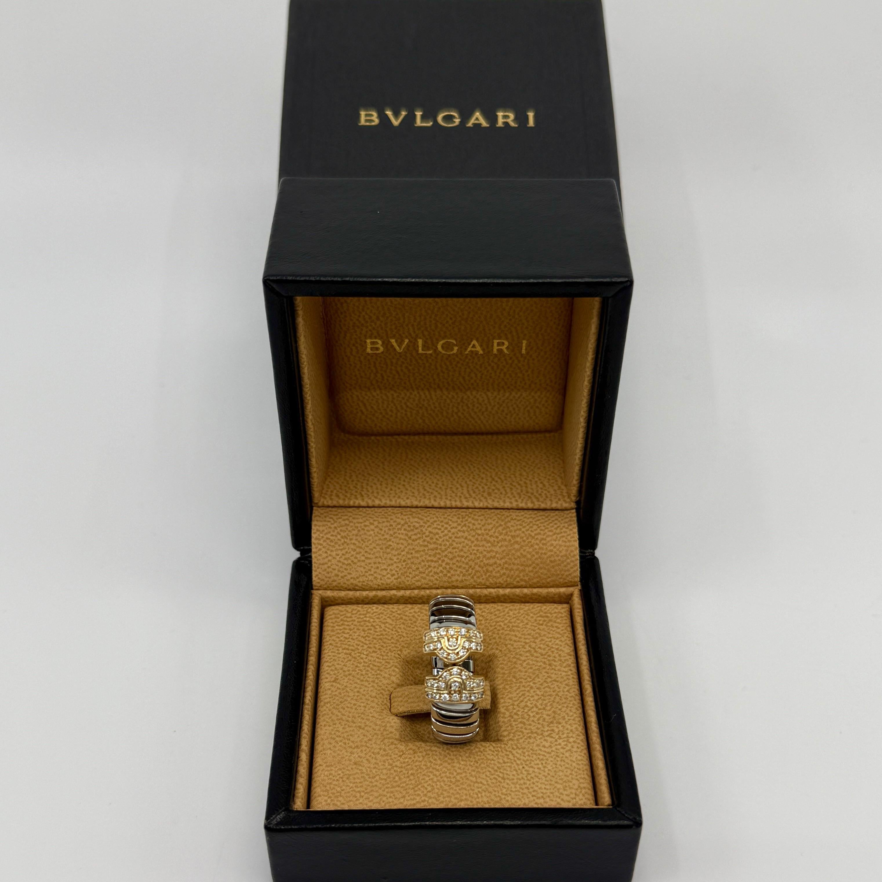 Rare Bvlgari Parentesi Tubogas 18k Yellow Gold & Stainless Steel Band Ring.

Stunning Bvlgari ring with signature Parentesi Tubogas style. Stainless steel flexible body of the bracelet and 18k yellow gold Dimond set ends.
Fully hallmarked with