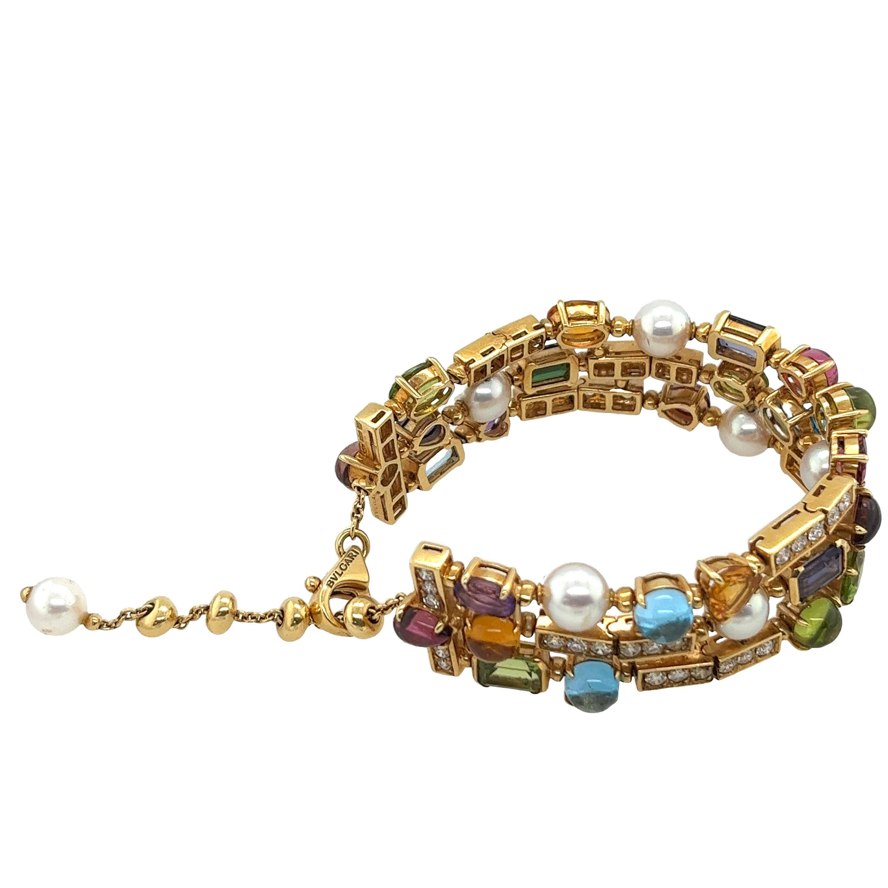 Rare Bvlgari 18ct Yellow Gold 3-row bracelet 
set with a mix of gemstones of cultured pearl iolith, 
peridot, citrine, topaz, garnet
in cabochon, oval, square, pear-shaped cut.
Surrounded by 1.80ct round brilliant cut diamonds in pave