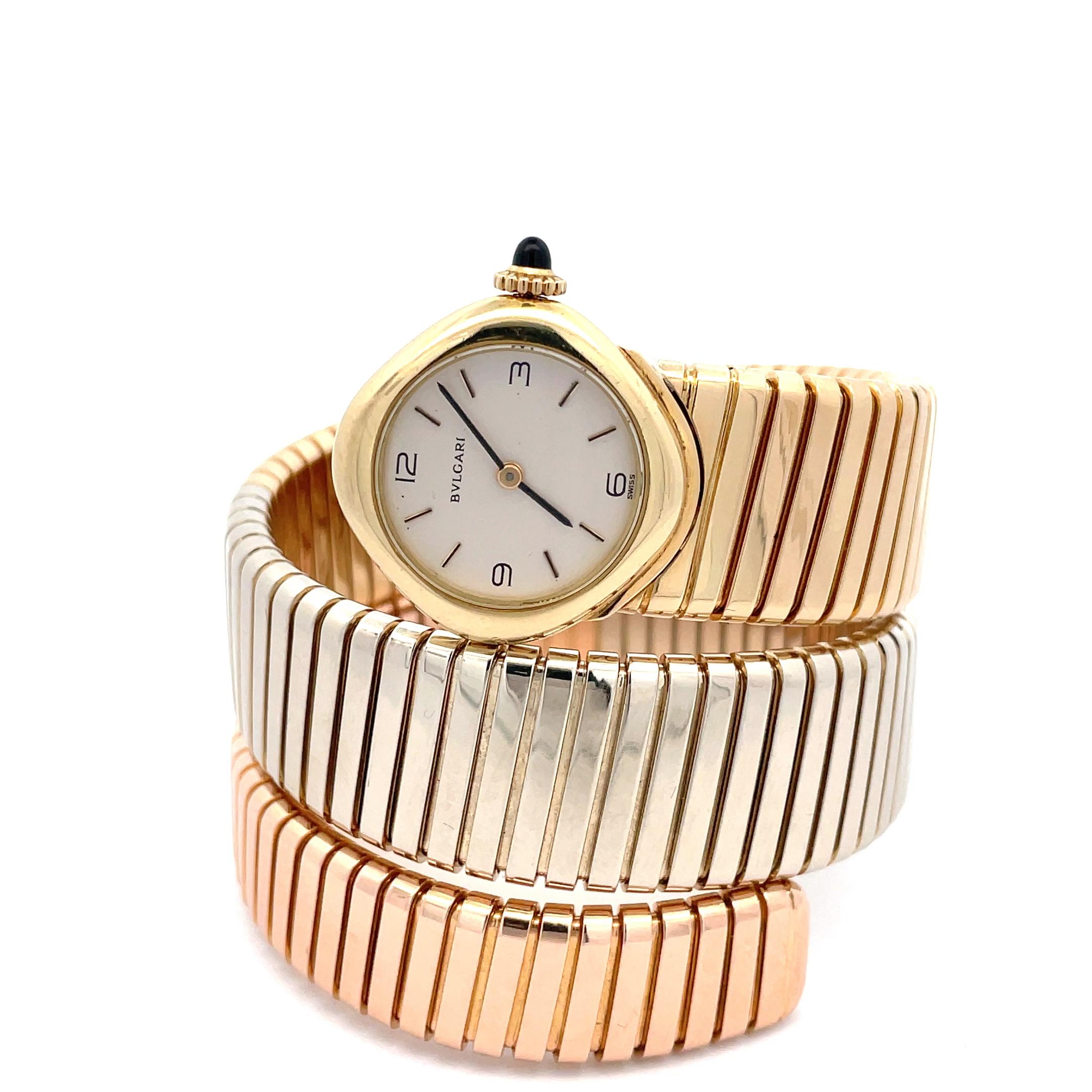 A unique version of the Bulgari Tubogas lady's watch in 18kt yellow, white and rose gold with a white dial with an elegant cabochon sapphire crown. Those large version of the Tubogas by Bulgari are among the rarest and most collectibles, fun fact in