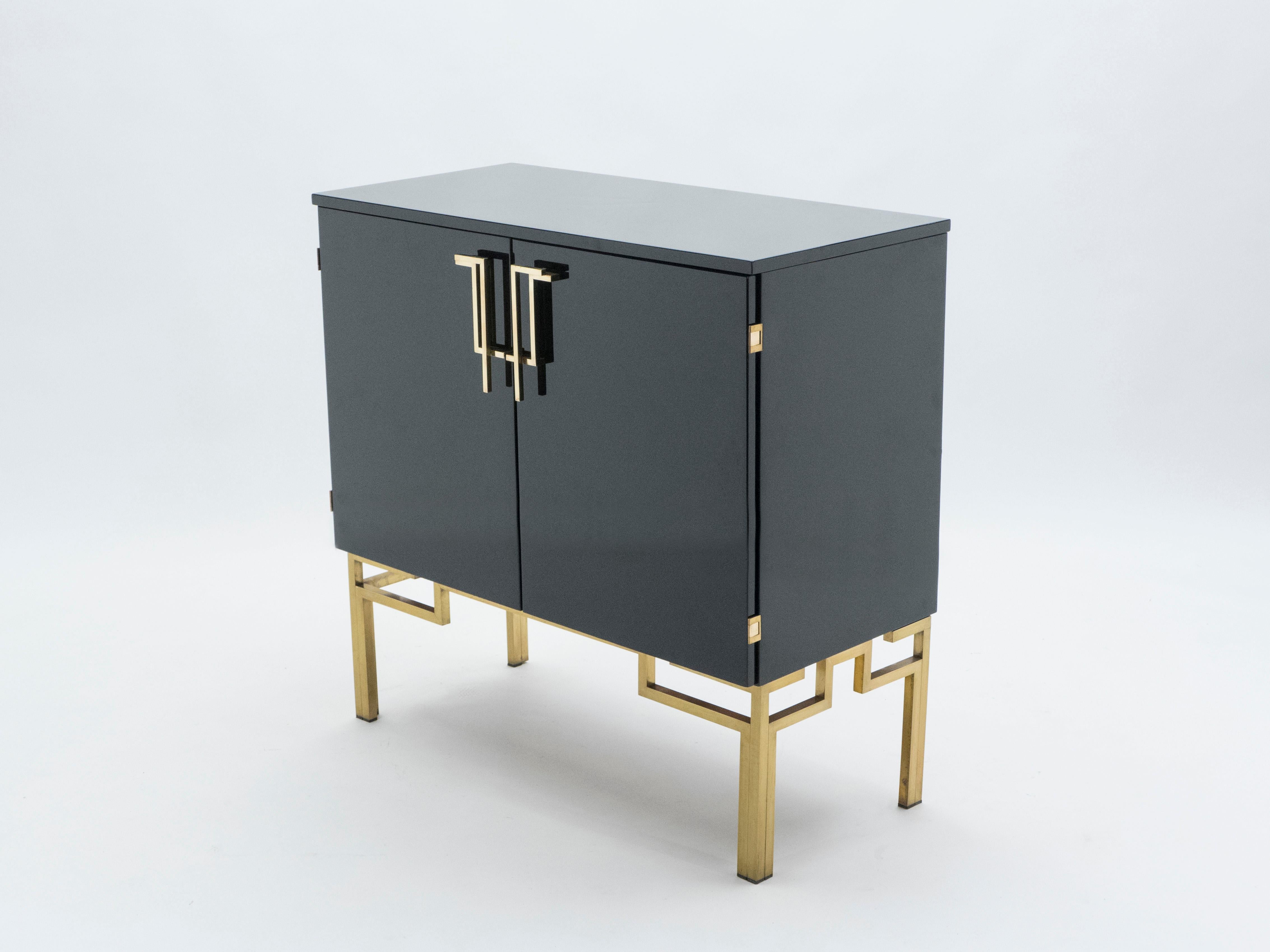 A very rare vintage Guy Lefevre for Maison Jansen cabinet bar made in the 1970s. Glossy black lacquer, paired with bright brass Asian inspired handles end feet, feels crisp and luxe. Featuring 2 doors and an opening top, it used to be high-end Hifi