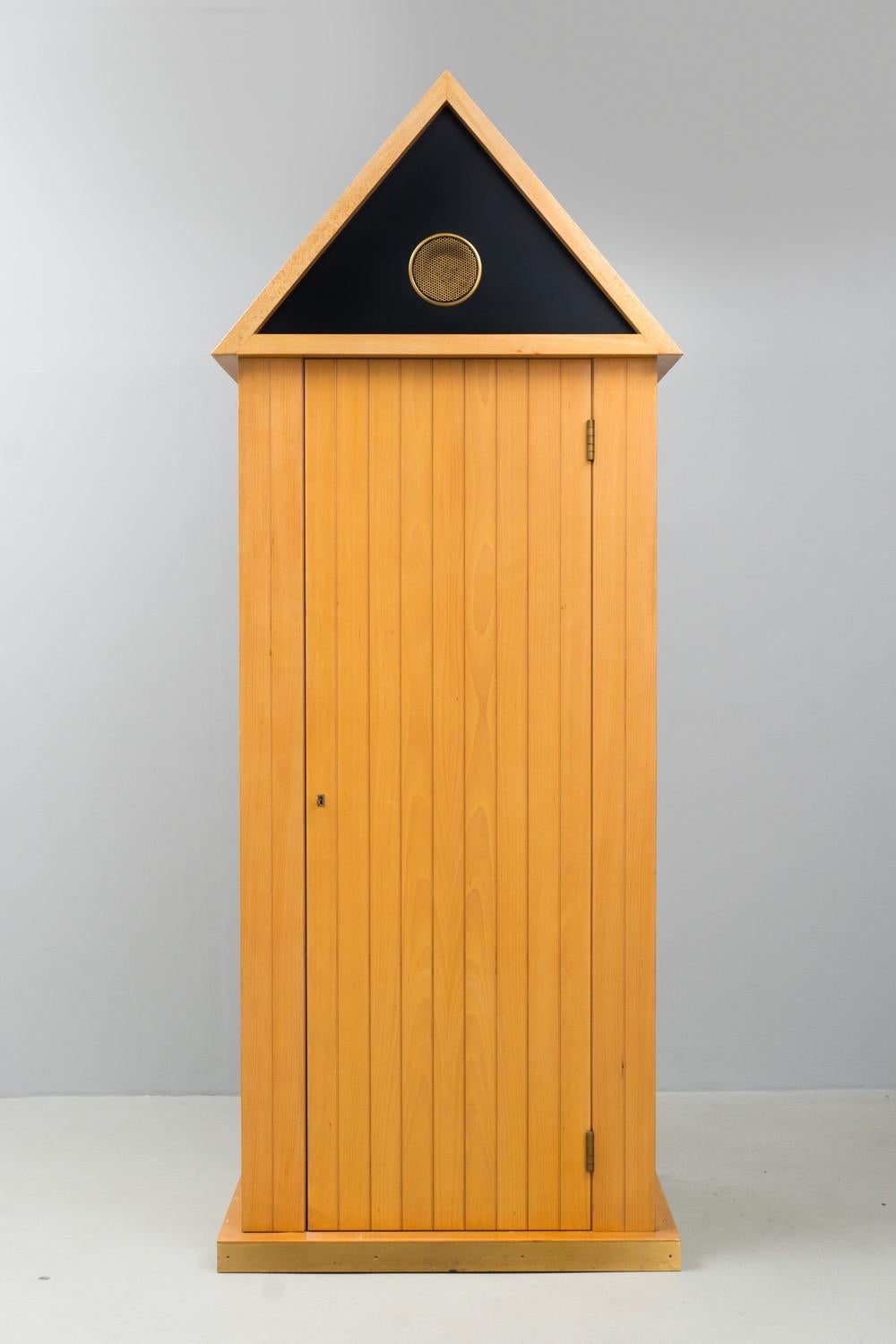 This very rare and eccentric closet is made of solid wood, it has drawers and shelves and a coat rack. The door can be locked with a key. Brass finishing on top and foot. Manufactured in Cantú by Bruno Longoni.

'Aldo Rossi (3 May 1931 – 4