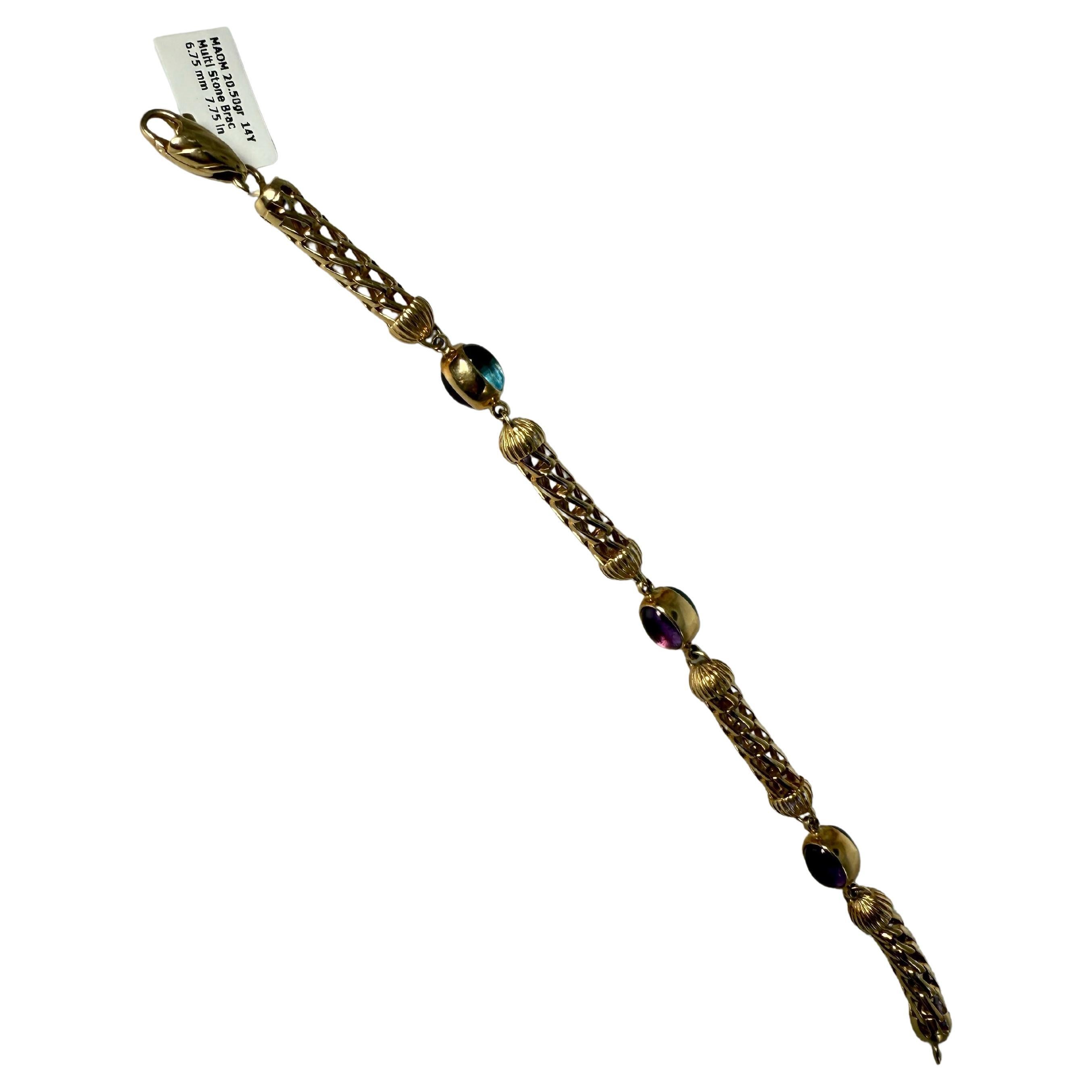 Rarement trouvé, ce bracelet élégant est serti de topazes et d'améthystes cabochons naturelles en or 14KT. La taille est de 7.75