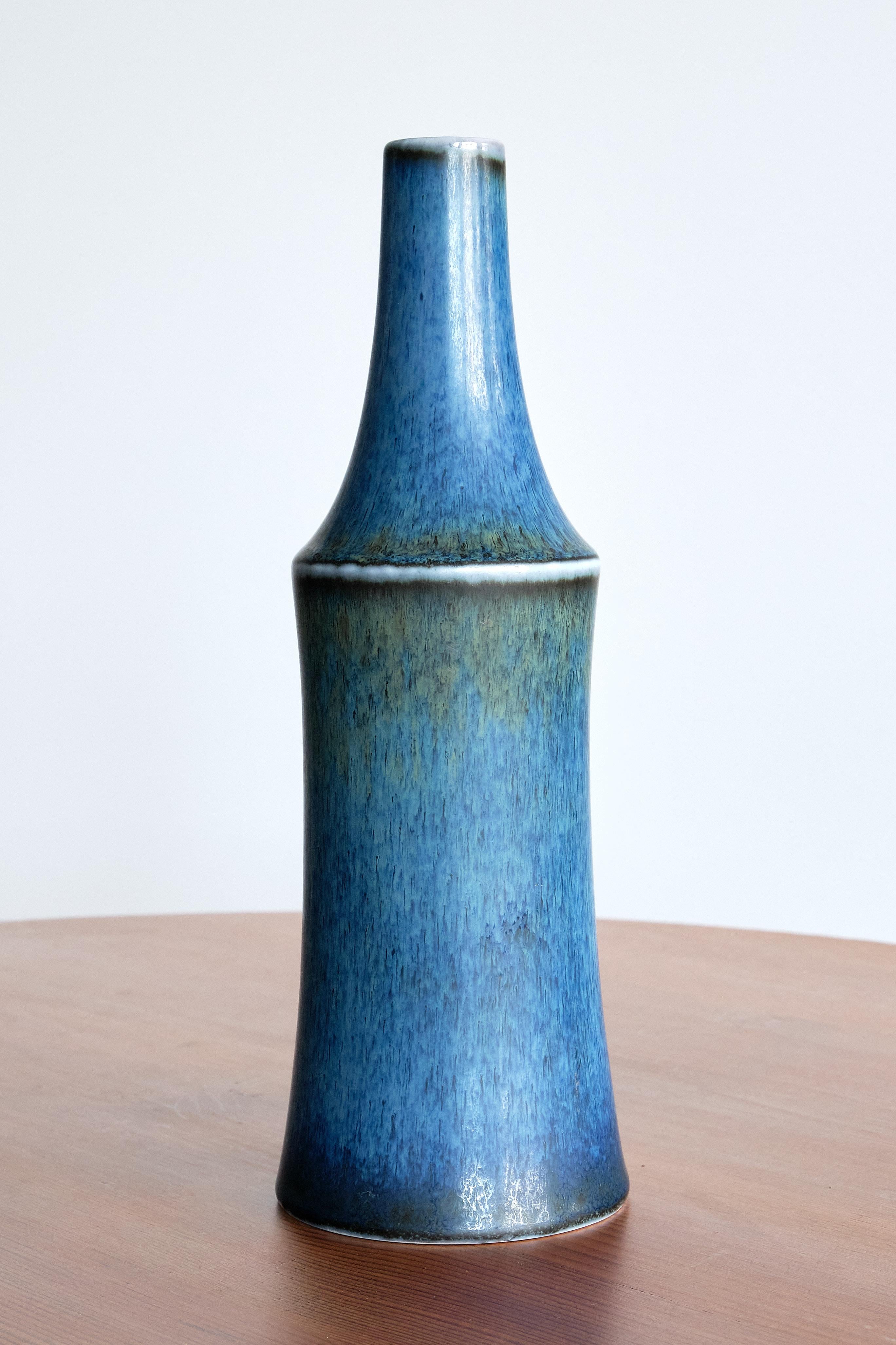 This rare stoneware vase was designed by Carl-Harry Stålhane and produced by Rörstrand in Sweden. The unique vase is finished in a blue harfur glaze which was entirely applied by hand. The hand finish allows for a beautiful transition of the colors