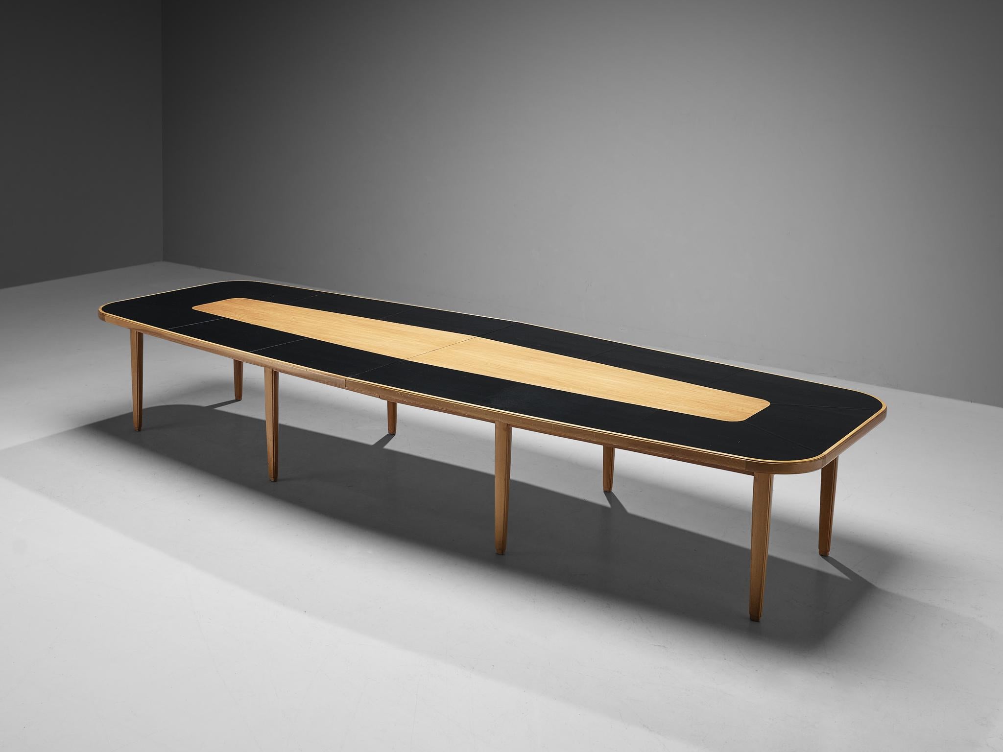 Carl Malmsten, dining or conference table, walnut, leather, Sweden, 1940s. 

Sizeable dining table that, due to its length, could easily function as a conference table as well. This table is designed by Swedish designer Carl Malmsten. The boat