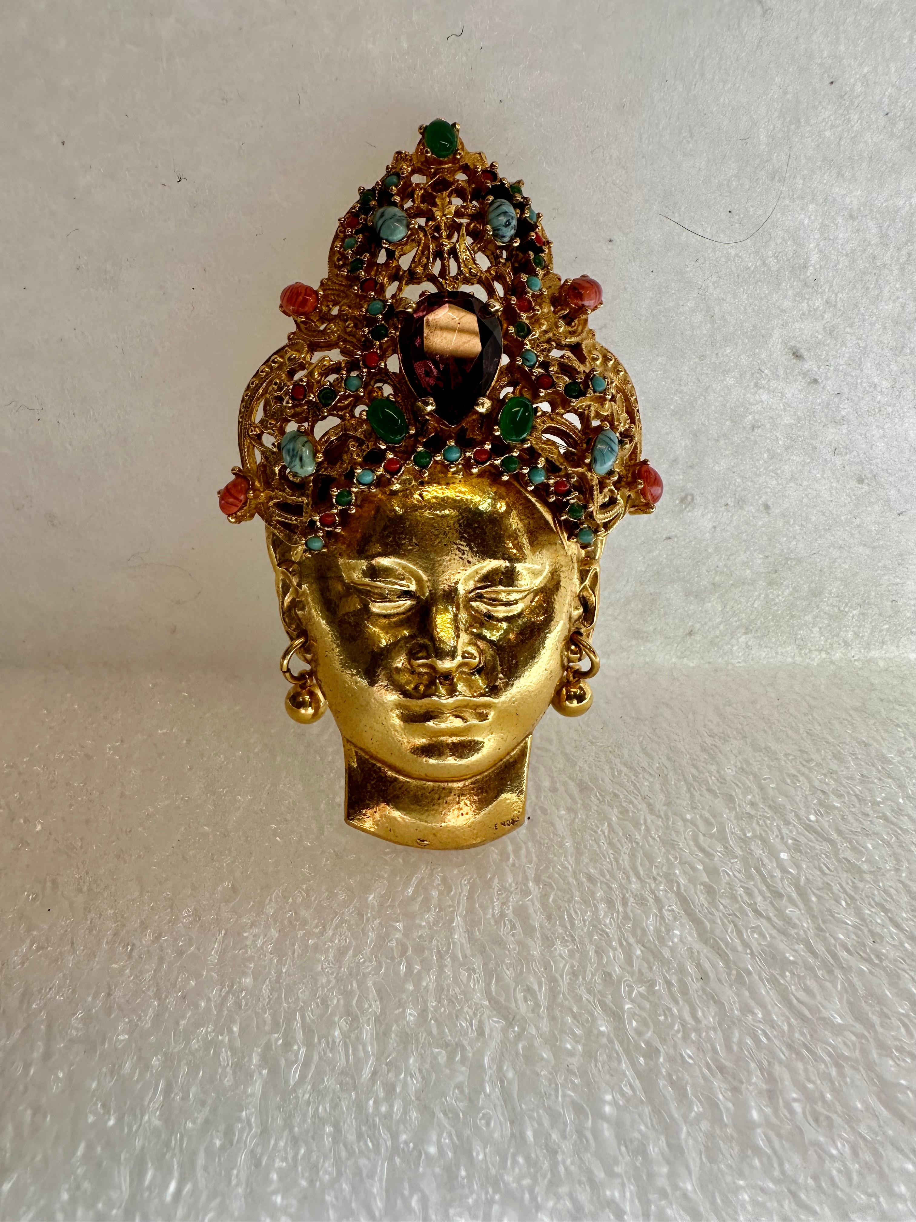This rare brooch pin is designed by Emile Monier for the Carlyle Co. . The oversize gold tone sculpted “statement” brooch is of an exotic, stunning Siamese entertainer wearing an elaborate multi jeweled headdress. The brooch is in excellent