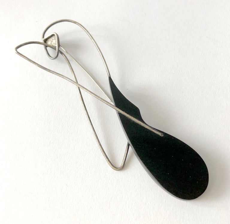 Large scale sterling silver and ebony wood brooch created by noted American modernist Carolyn Gleick Rosene, circa 1950's.  Brooch measures 5 5/8