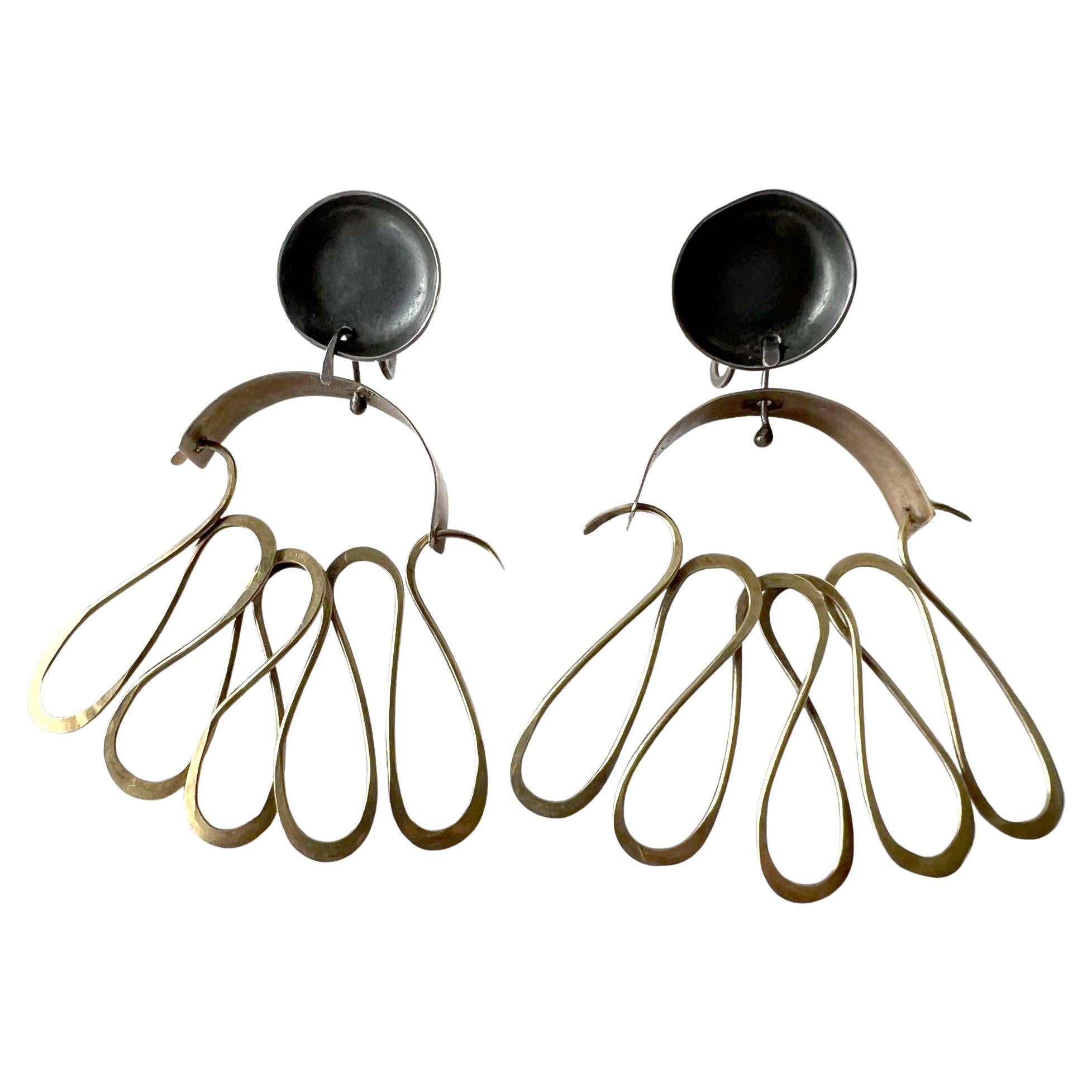 Rare screw back earrings created by modernist jeweler Carolyn Pence, circa 1950s.  Earrings are completely handcrafted 14K gold and with sterling silver findings that are in working order. They measure 2 3/8