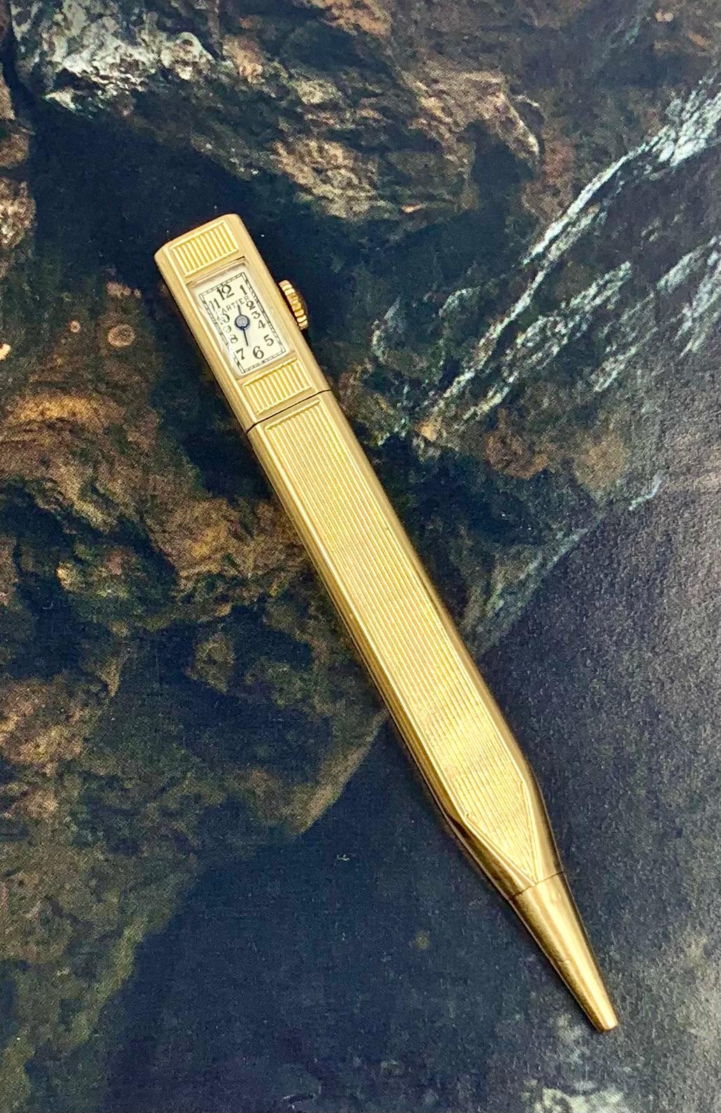 Cartier rare and unusual Art Deco period 14K yellow gold retractable pencil watch
1920's
Sleek and elegant, rectangular ribbed gold case, watch set in the upper part, tapered arrow shaped end, silvered dial, Arabic numerals, signed Cartier
Movement: