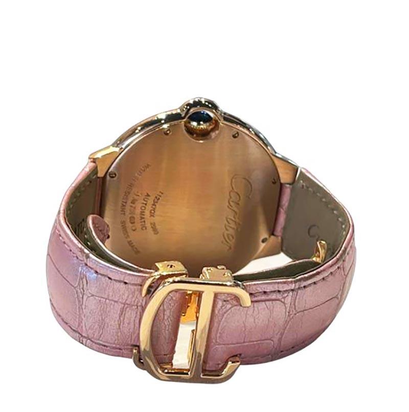 Brand: Cartier

Model: Ballon Bleu 

Movement: Automatic 

Case Size: 36 mm 

Dial: Roman Numeral Hour Markers

Bezel: 18K Rose Gold 

Case Material: 18K Rose Gold 

Band Material:  Pink Crocodile Leather

Crystal: Scratch-Resistant Sapphire
