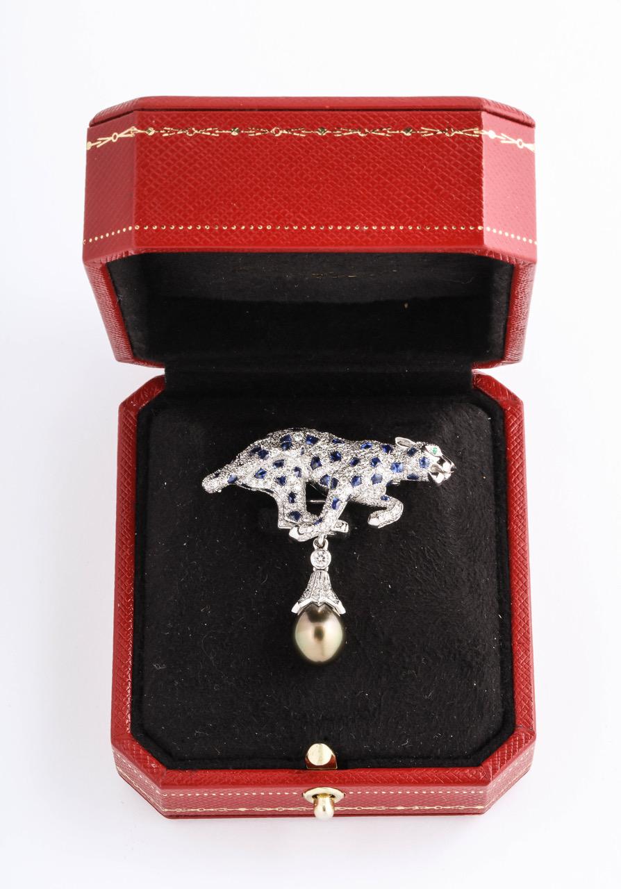 Rare Cartier Diamond Sapphire Tahitian Pearl Panther Pin in original Cartier box.
Pendant with removable Tahitian pearl drop, set with approximately 1.50 carats fine diamonds, 1.carat cabochon sapphires, mounted stamped platinum. Stamped Cartier PT