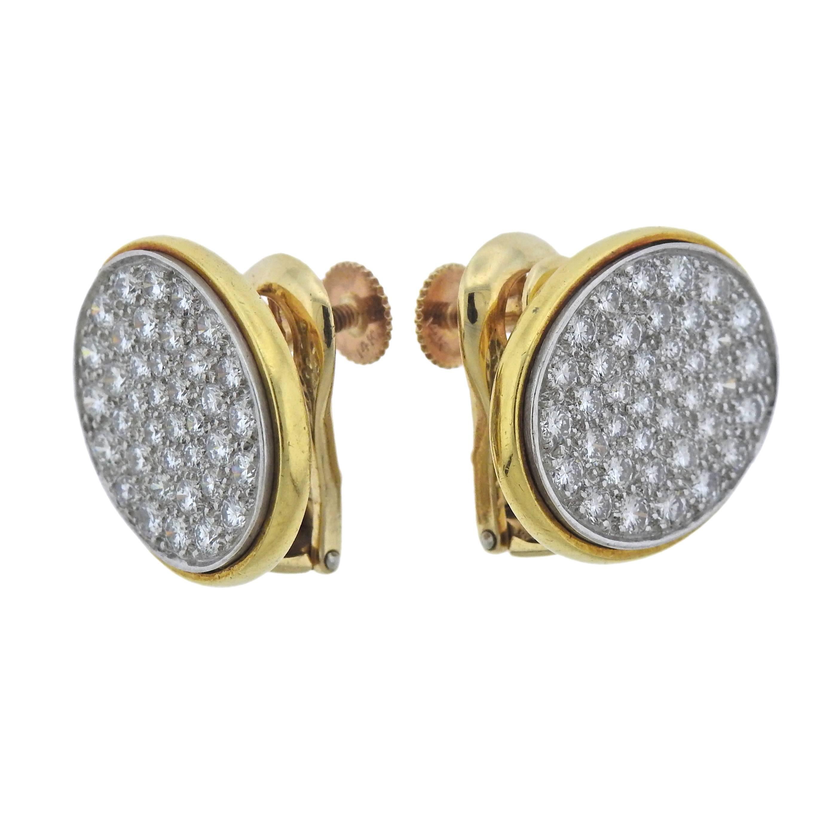 Rare 18k gold and platinum oval earrings, designed by Dinh Van for Cartier, set with approximately 2.00ctw in G./VS diamonds. Earrings are 20mm x 17mm, weigh 19.7 grams. Marked: Cartier, 18k, irid. plat, 64095.