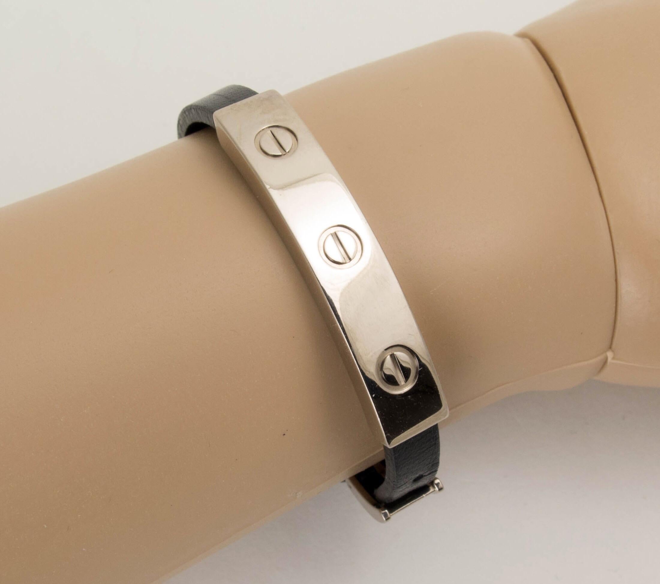 A rare take on the classic Cartier Love Bracelet, this example features a three screw motif in 18K white gold set on an adjustable black calfskin leather strap with an 18K white gold buckle. The leather soft and pliable, showing wear from use.