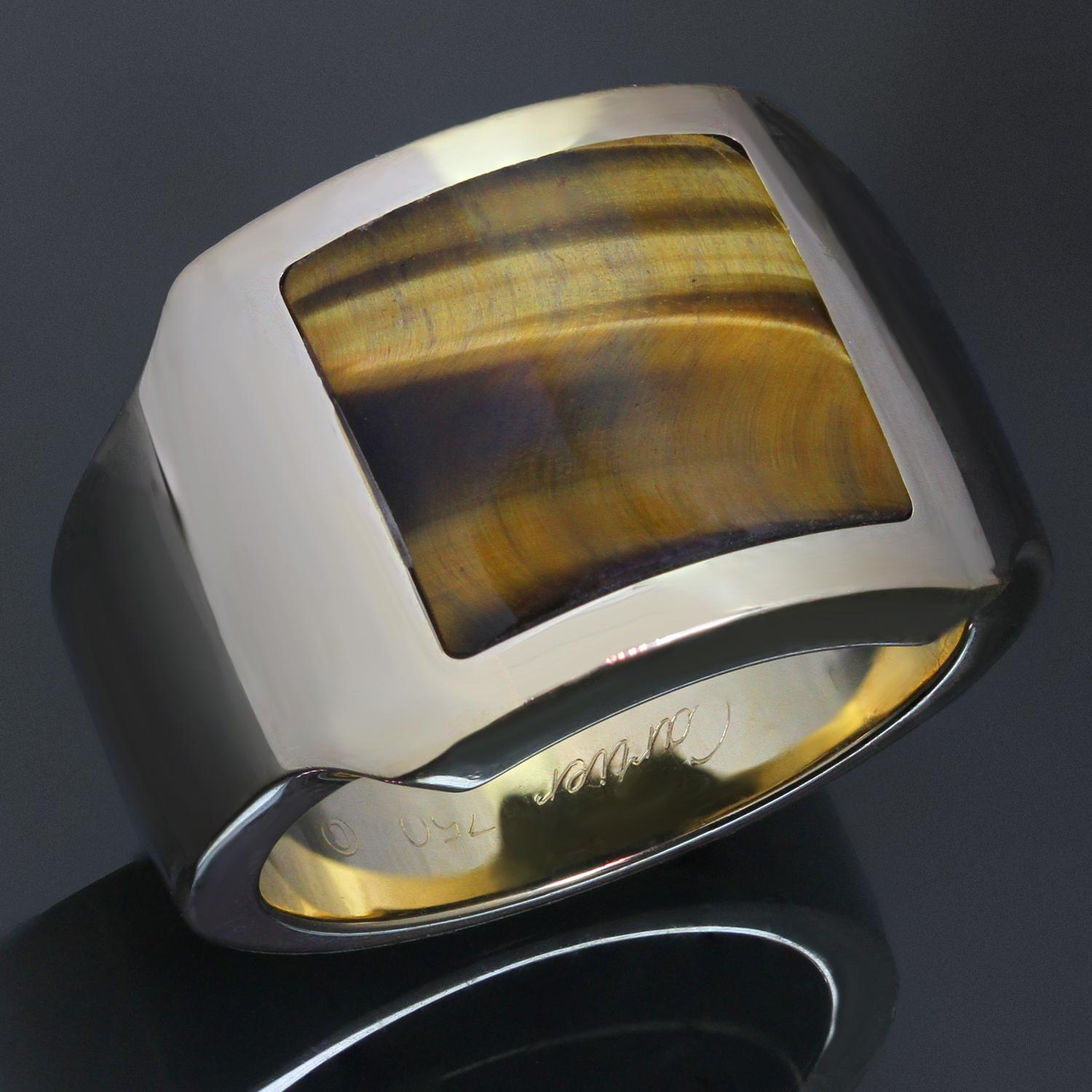 This rare Cartier men's ring from the classic Santos collection is crafted in 18k yellow gold and set with square-shaped tiger eye gemstone. Made in France circa 1990s. Measurements: 0.62