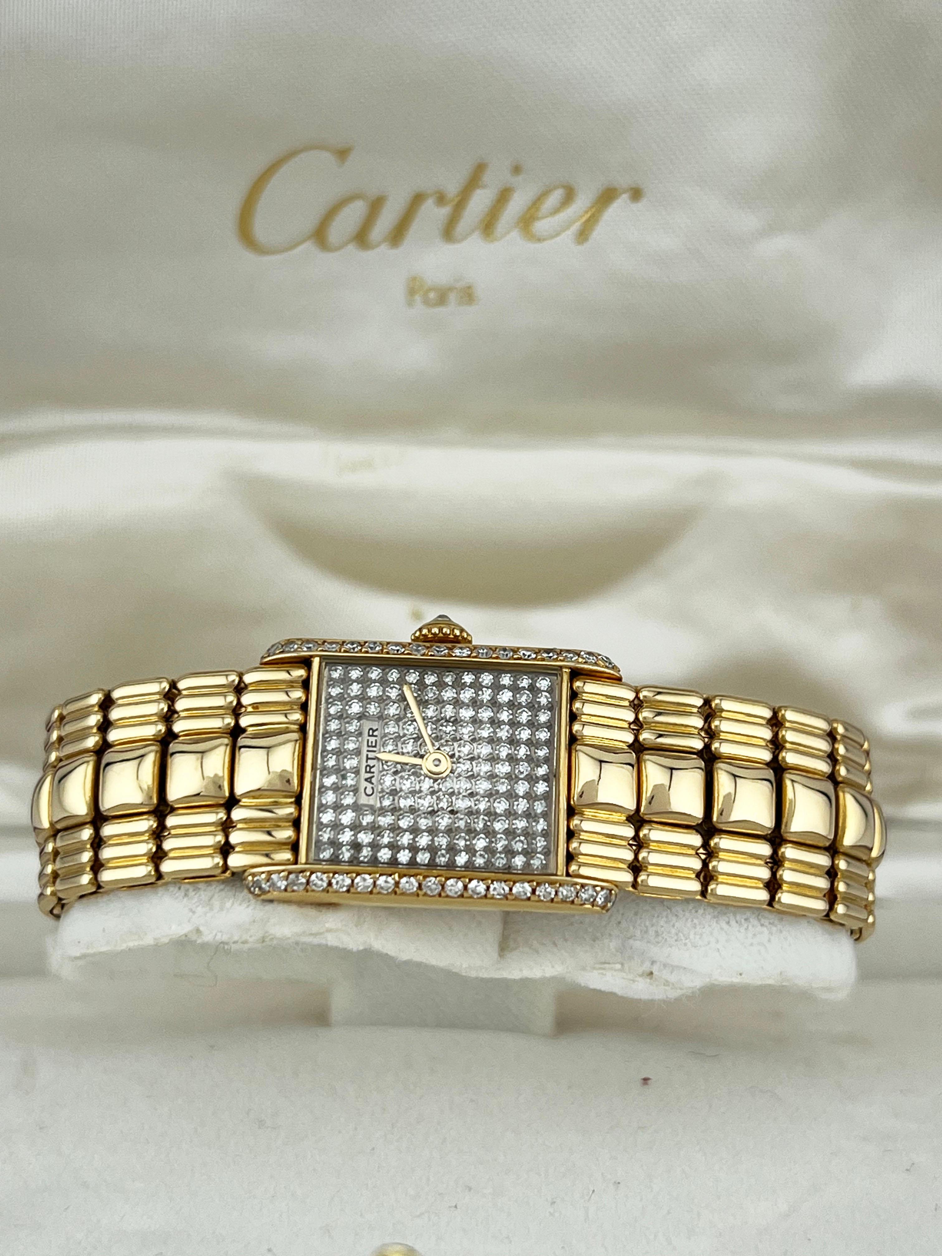 Year: 1988
Model: Cartier Tank Louis (Mechanical)
Case Material: 18K Yellow Gold 
Band: 18K Yellow Gold 
Bezel:  Diamond Bezel 
Dial: Pave Diamond Dial 
Face: Sapphire Crystal 
Case Size: 21mm 
Includes: 
-Original Cartier Box & Paper
-Certified