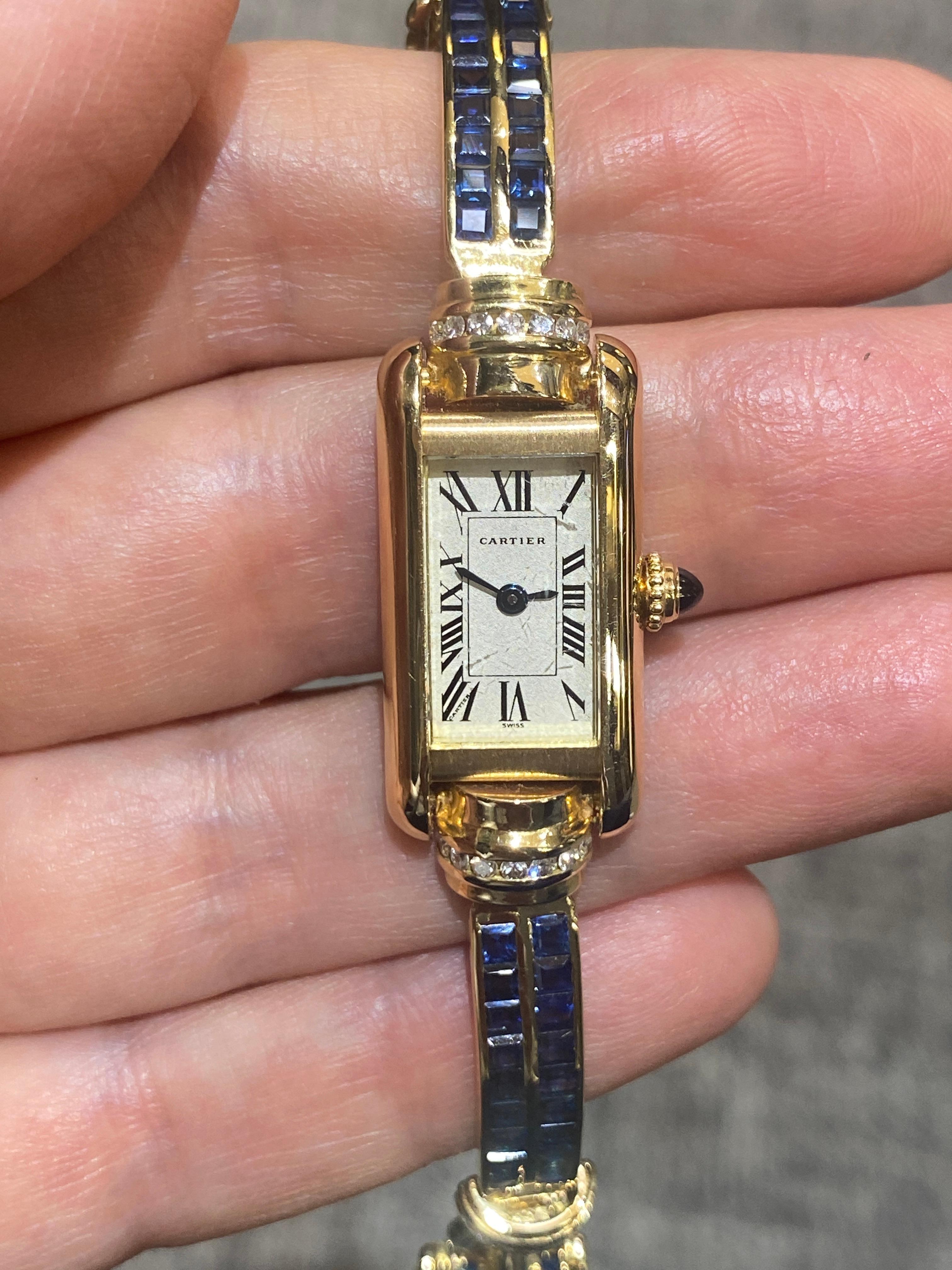 This rare Cartier Tank watch has an 18k gold bracelet adorned with round cut diamonds and invisible setting sapphires. The length of the bracelet is 17cm. It is a stunning piece.