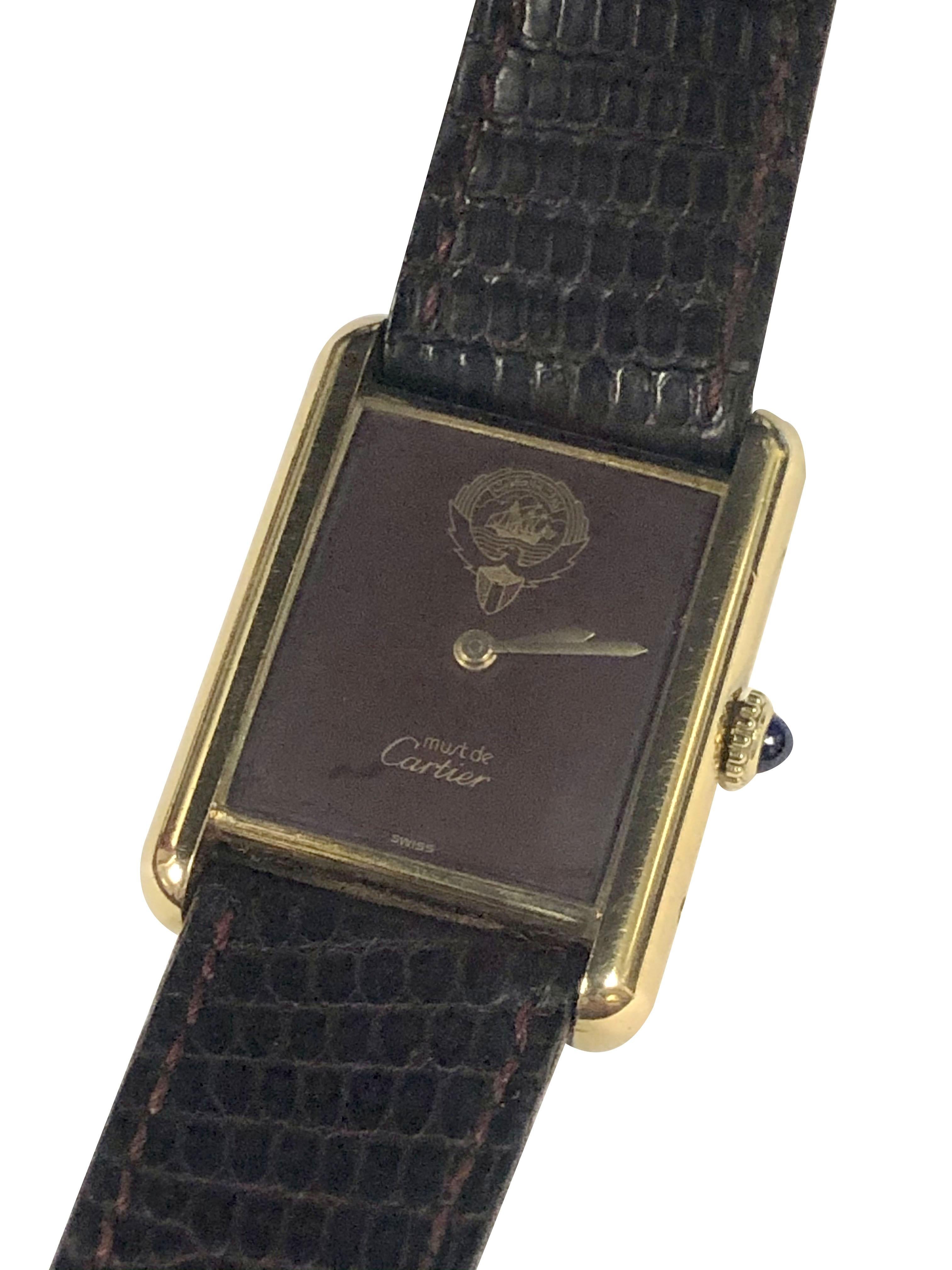 Circa 1980s Cartier Special Presentation Wrist Watch and Pen set for Kuwait. 30 X 24 M.M. 2 Piece Vermeil ( Gold Plate on 925 Sterling Silver ) case, 17 Jewel Mechanical, Manual wind Movement, Sapphire Crown, Burgundy Dial with Gold Kuwait Coat of