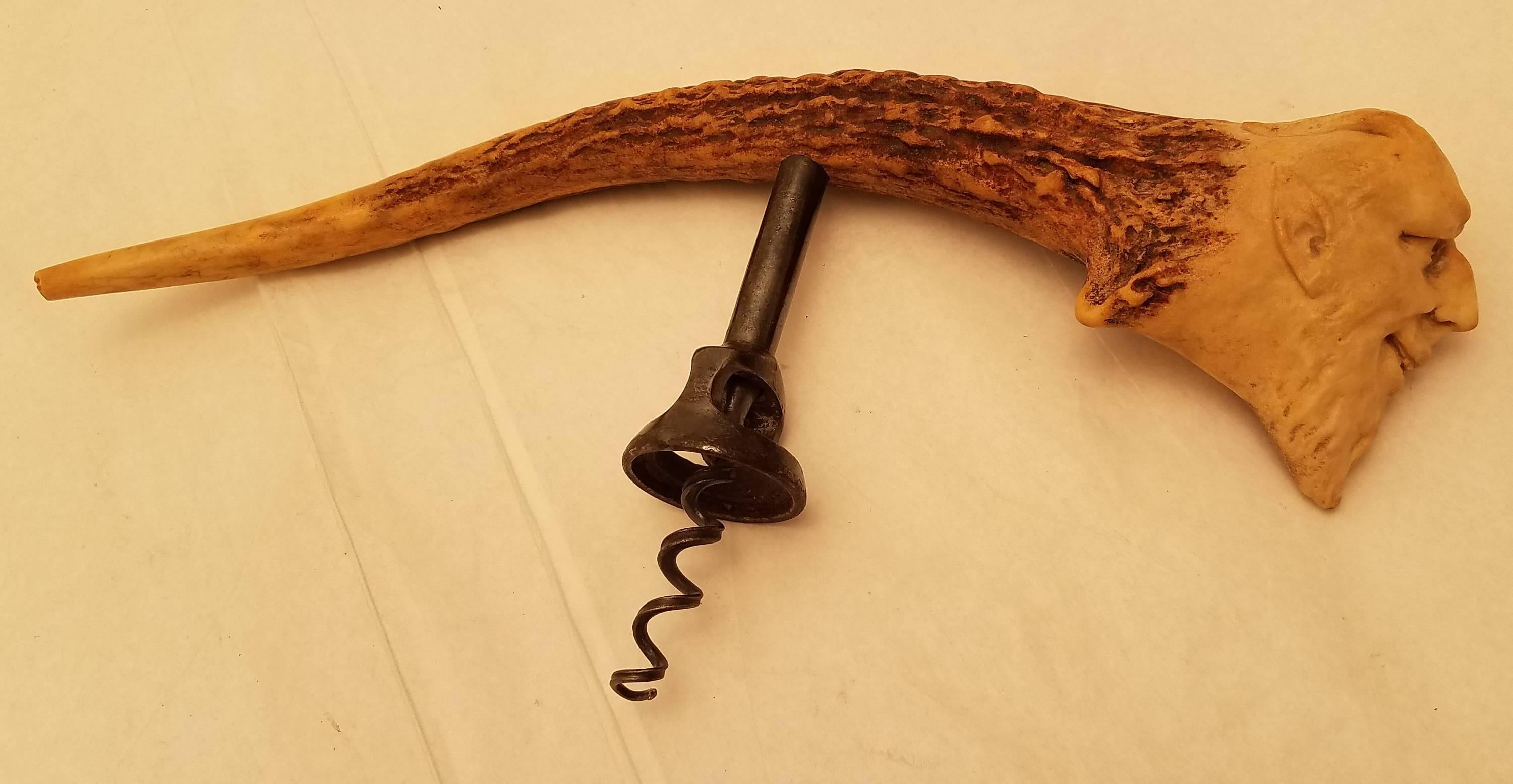 A rare and whimsical carved horn corkscrew with intricate novelty carvings of a man's face and designs. Measuring 9.7 inches long.

We hand polish all items before shipping them out, but if there is interest for a professional polishing and/or