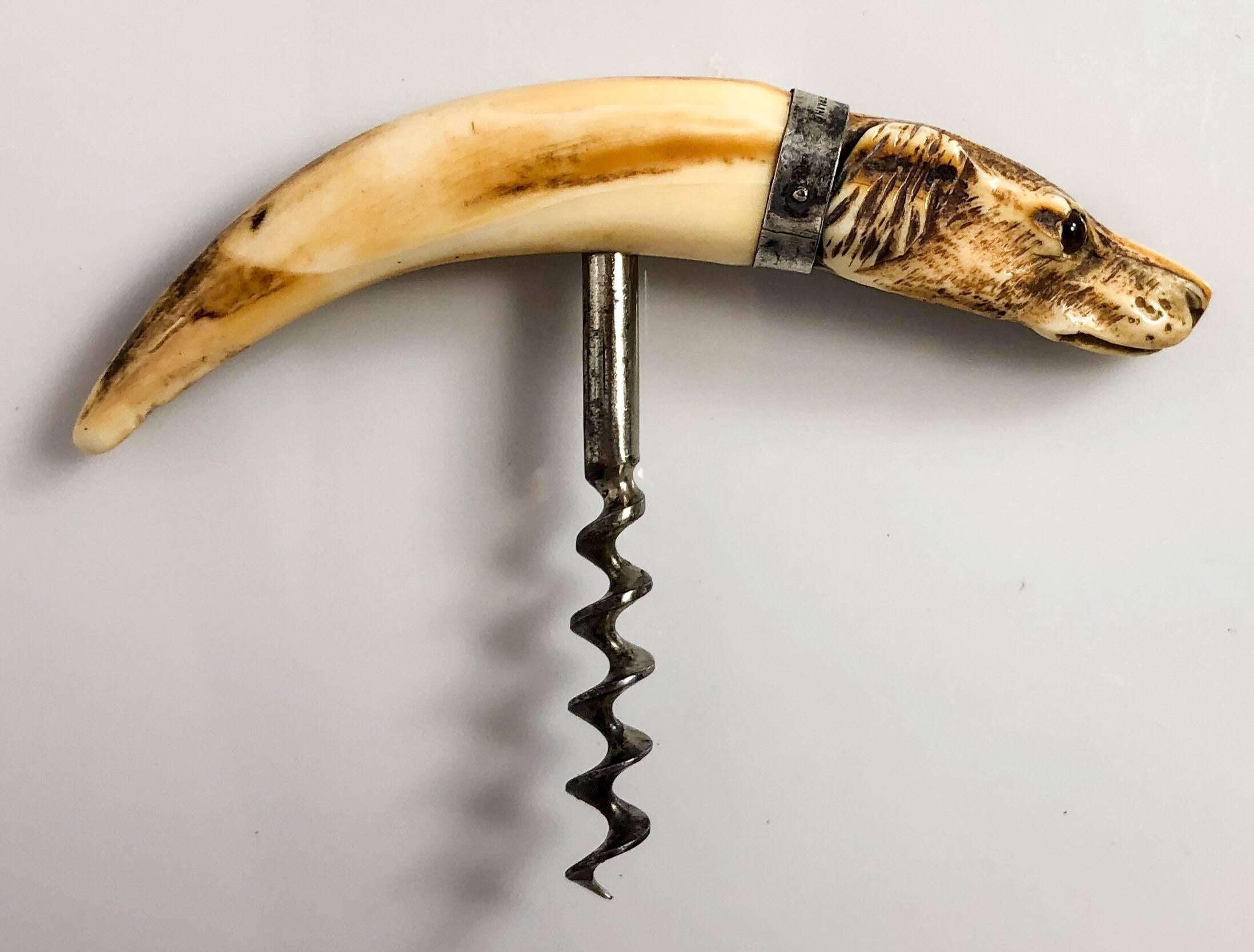 Rare carved hunting dog corkscrew with sterling silver mounts, circa 1890.