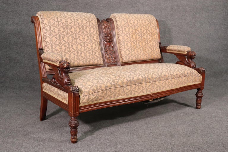 The detail of the frame on this sofa is absolutely outstanding. The carved faces are fantastic and indicative of the best of RJ Hroner's works. There is a matching pair of chairs that matches this settee listed separately. The upholstery is original