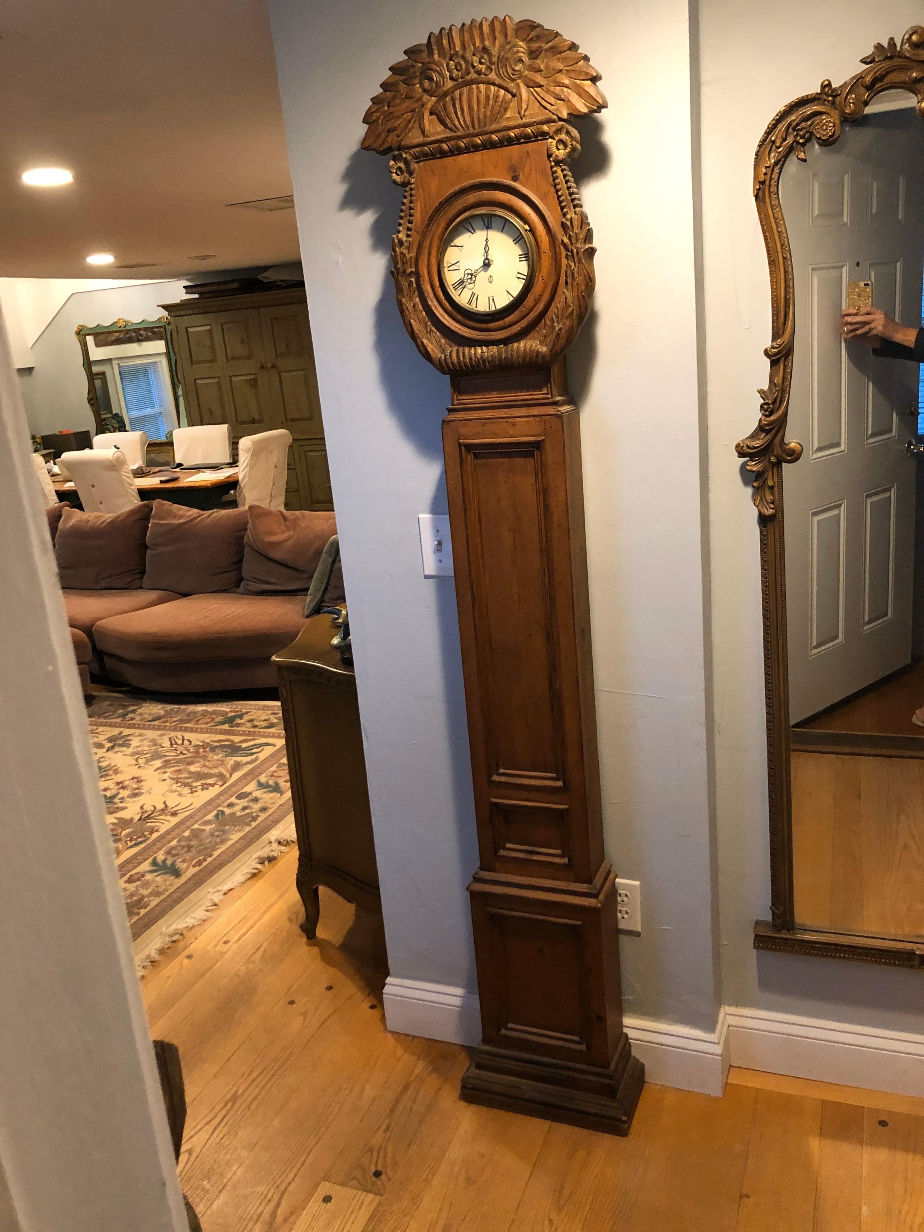 Rare carved wooden chapman longcase clock. Amazing and ornate detail to this hand carved and gilded floral bouquet top .Garnished with scrolled acanthus sides. Nice symmetrical trimmed box neck with stepped baseboard. Extremely feminine and