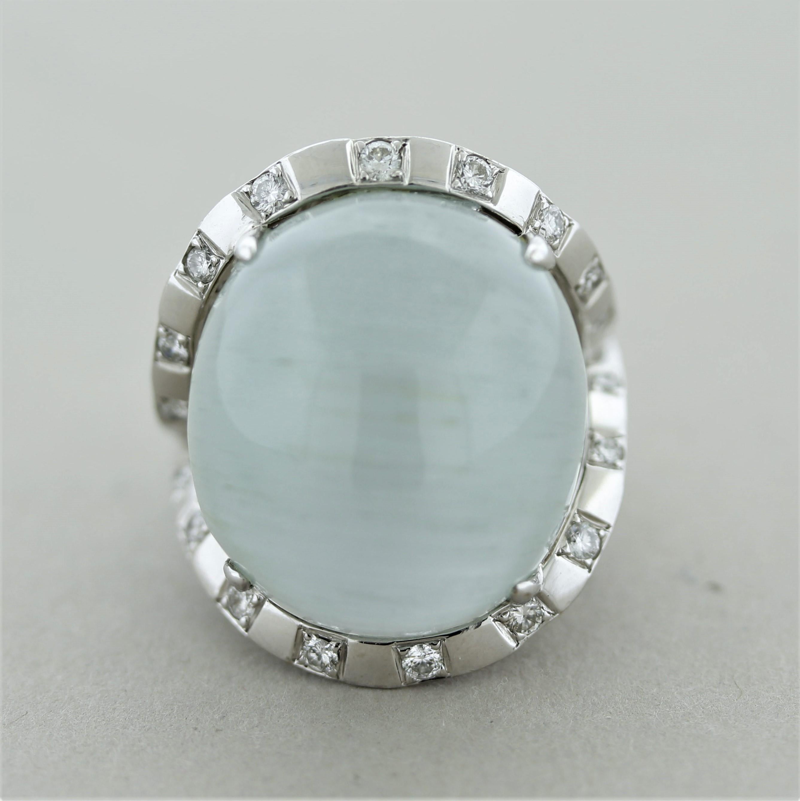 A large, unique and rare gemstone! The ring features a 32.42 carat cabochon aquamarine with a rare cats eye effect. Natural growth tubes in the stone run across it horizontally which creates the “cats eye” effect. Accenting the fun aquamarine are