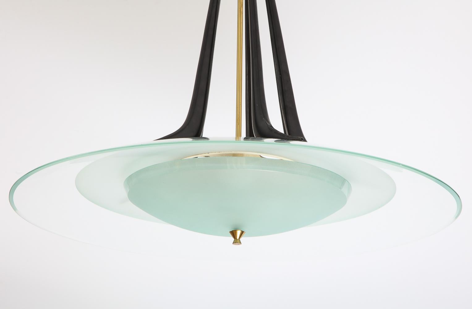 Lacquered metal, frosted glass, clear glass and brass. A rare example by Max Ingrand with sculptural black-lacquered supports at the top. There are five E26 sockets.