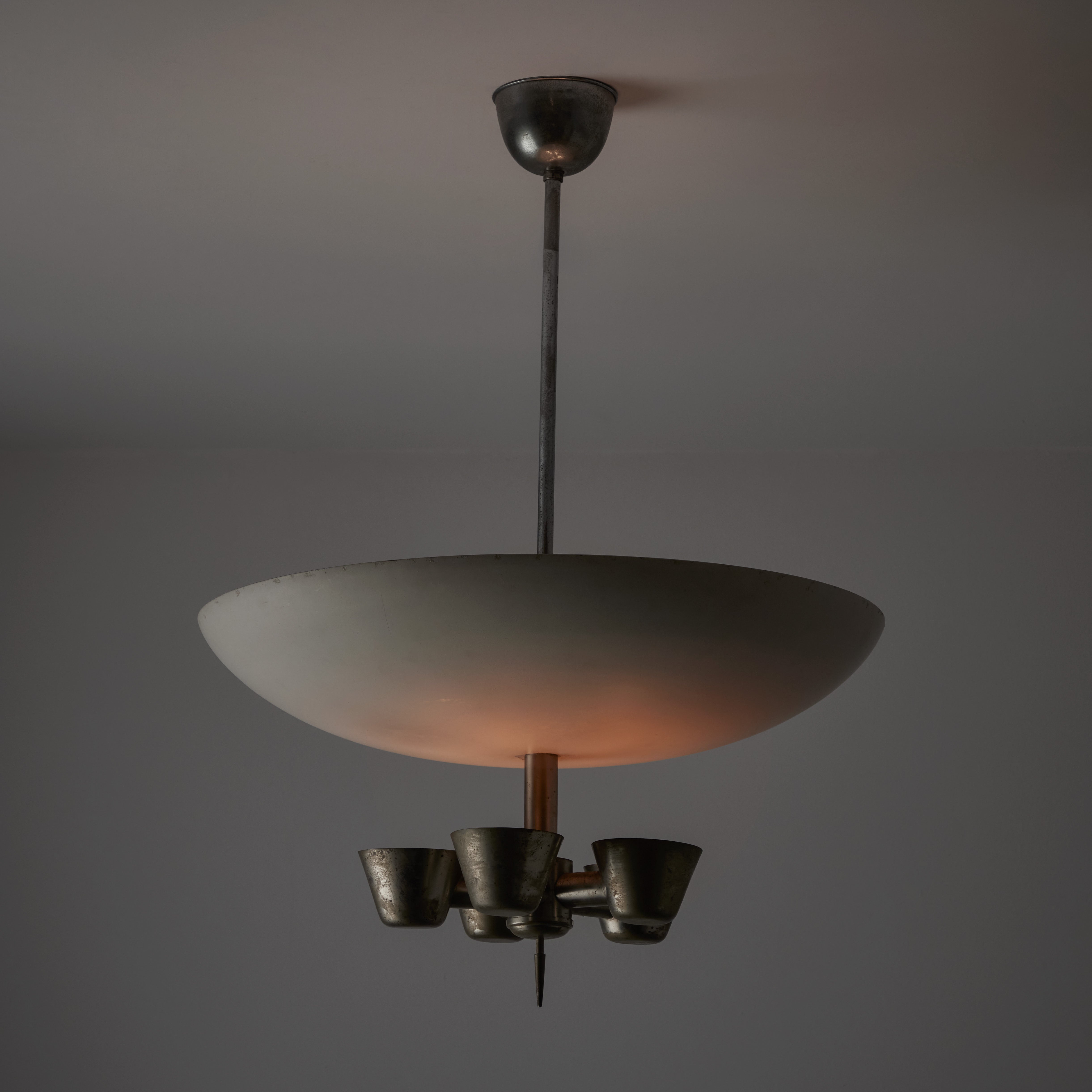 Rare ceiling light by Stilnovo. Designed and manufactured in Italy, circa the early 1950s. This is most likely a first edition and very rare make from Stilnovo. A gothic ceiling lamp featuring a lower 5 socket brass sequence which is met by an upper