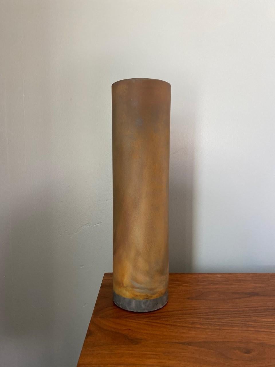 Beautiful vintage and rare ceramic piece. This beautiful vase is column shaped and presents a glaze technique and color that imitates shades of rust. Browns, yellows, gold hues permeate thru the piece. The illusion of metal/rust in the media of