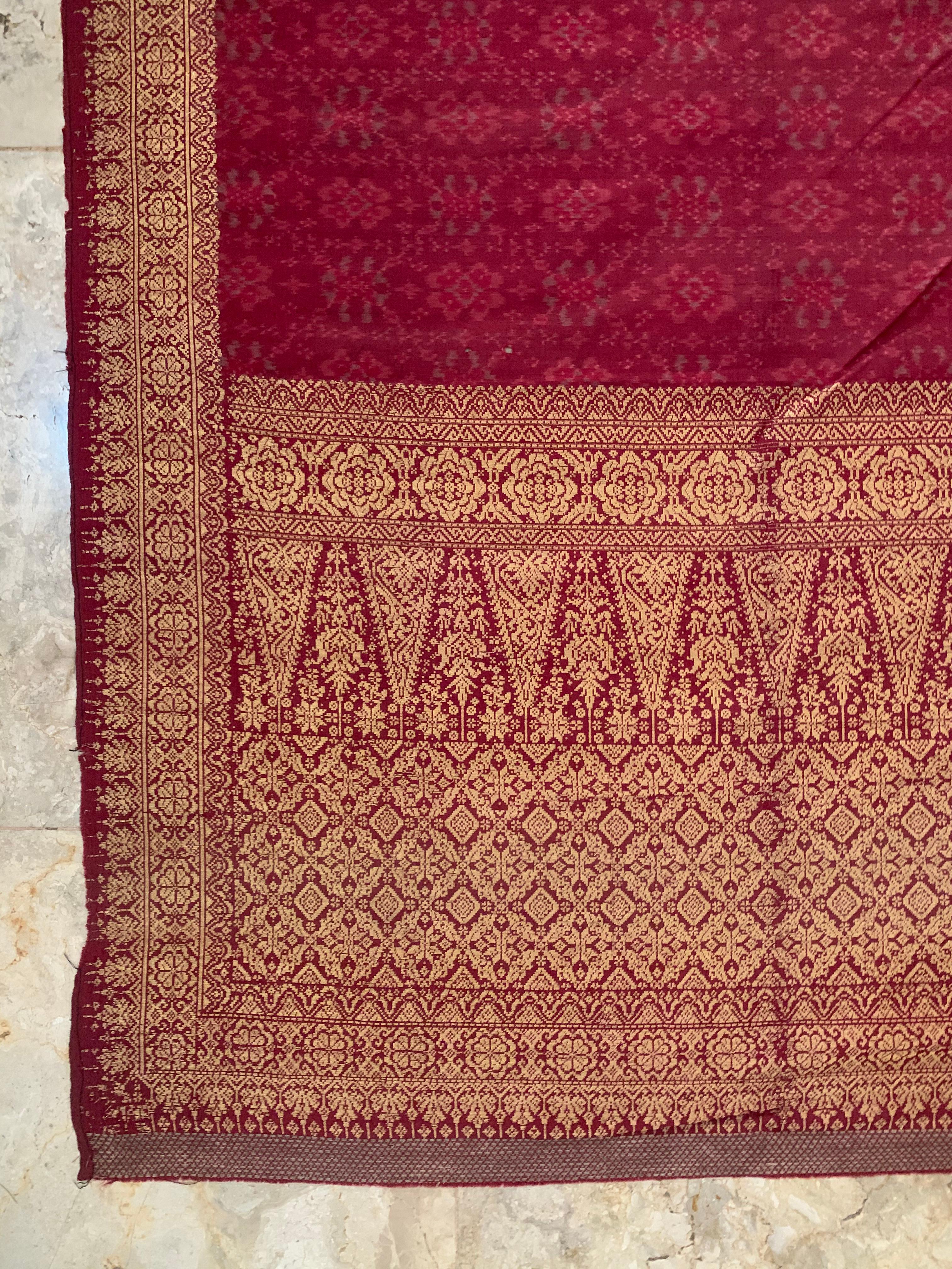 A wonderful and rare example of a Palembang Ceremonial Woven Silk Ikat (Songket Limar) from the Malay people of Sumatra. It features a mix of red & pink silks and a unique process which merges gold leaf to the embroidery. This process involves