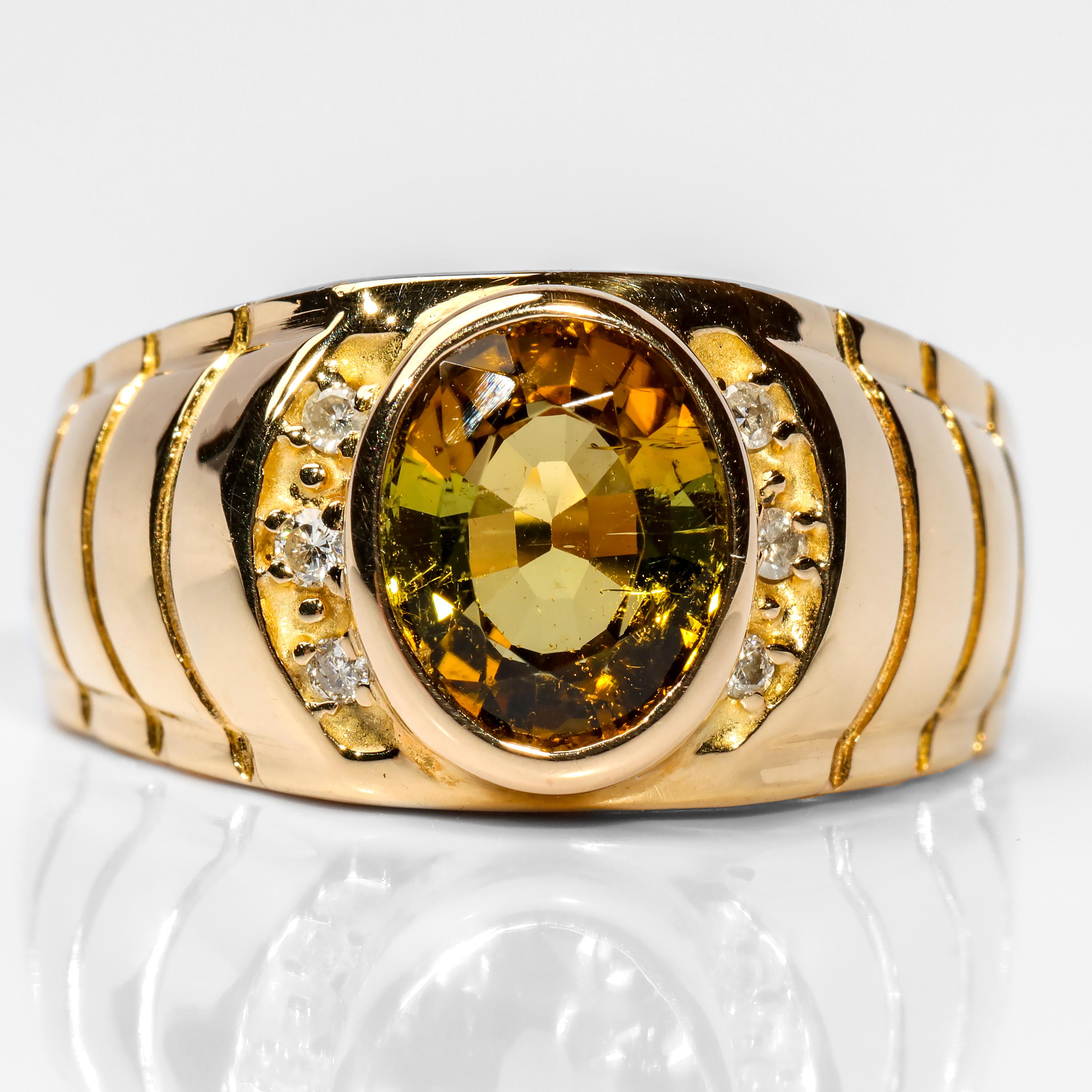 This vintage 1980s 14K yellow gold and diamond men's ring features quite the curiosity: the greenish-yellow and golden brown tourmaline bezel-set front and center is certified by Stone Group Labs as a 