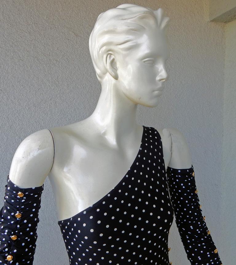 One of the most memorable and collectible 3 pc black and white polka-dot swimsuit ensemble by Chanel 1989.   Designed in a very appealing sexy one shoulder one piece with adjustable length skirt and ruched arm sleeves.   Entire ensemble boasts a