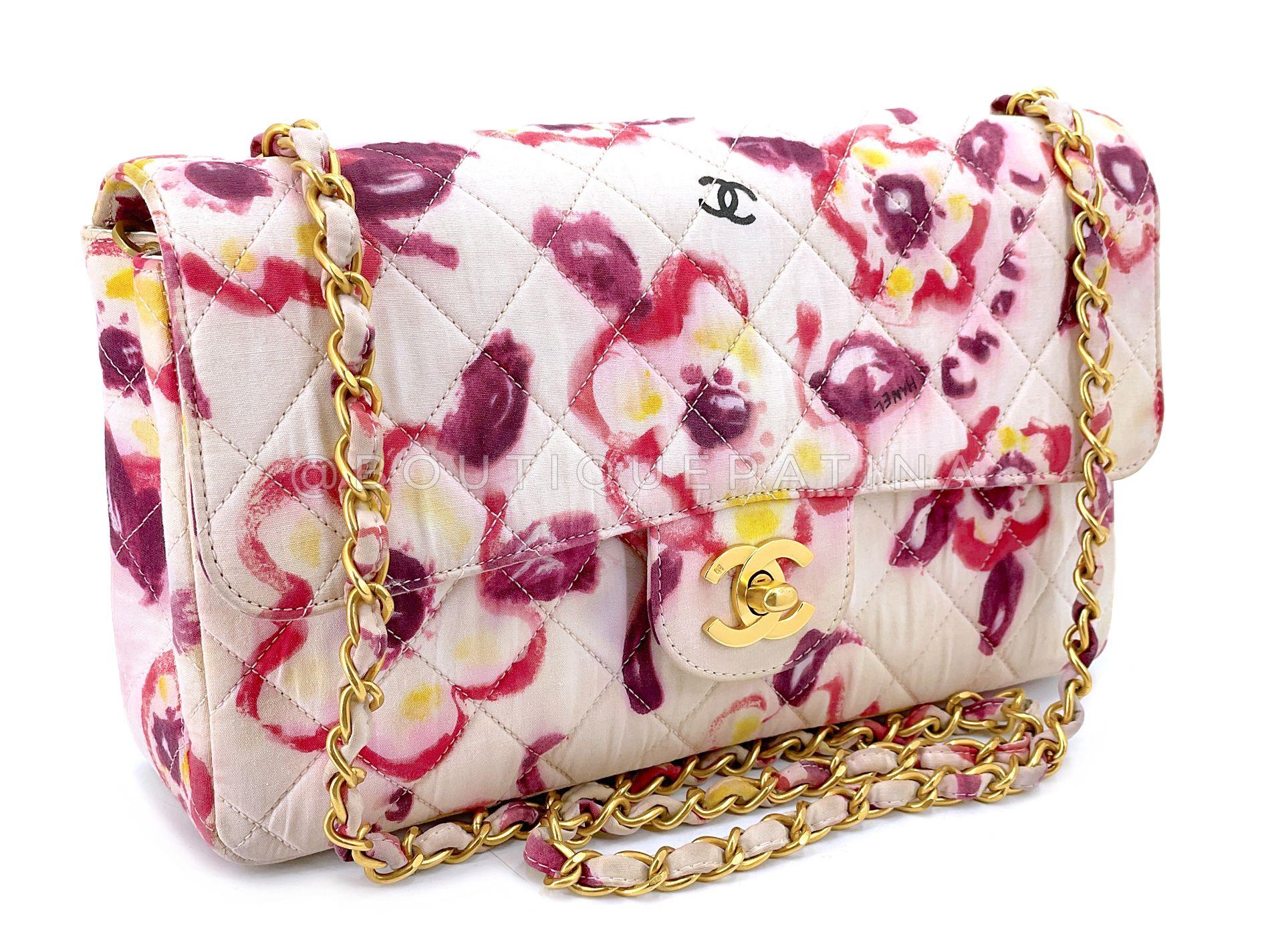 Store item: 68568
A whimsical printed medium flap with 24k gold plated hardware is this Rare Chanel 1996 Vintage Watercolor Floral Medium Classic Flap Bag 24k GHW. 

A single crossbody strap and a single flap, but with the dimensions and frame of a