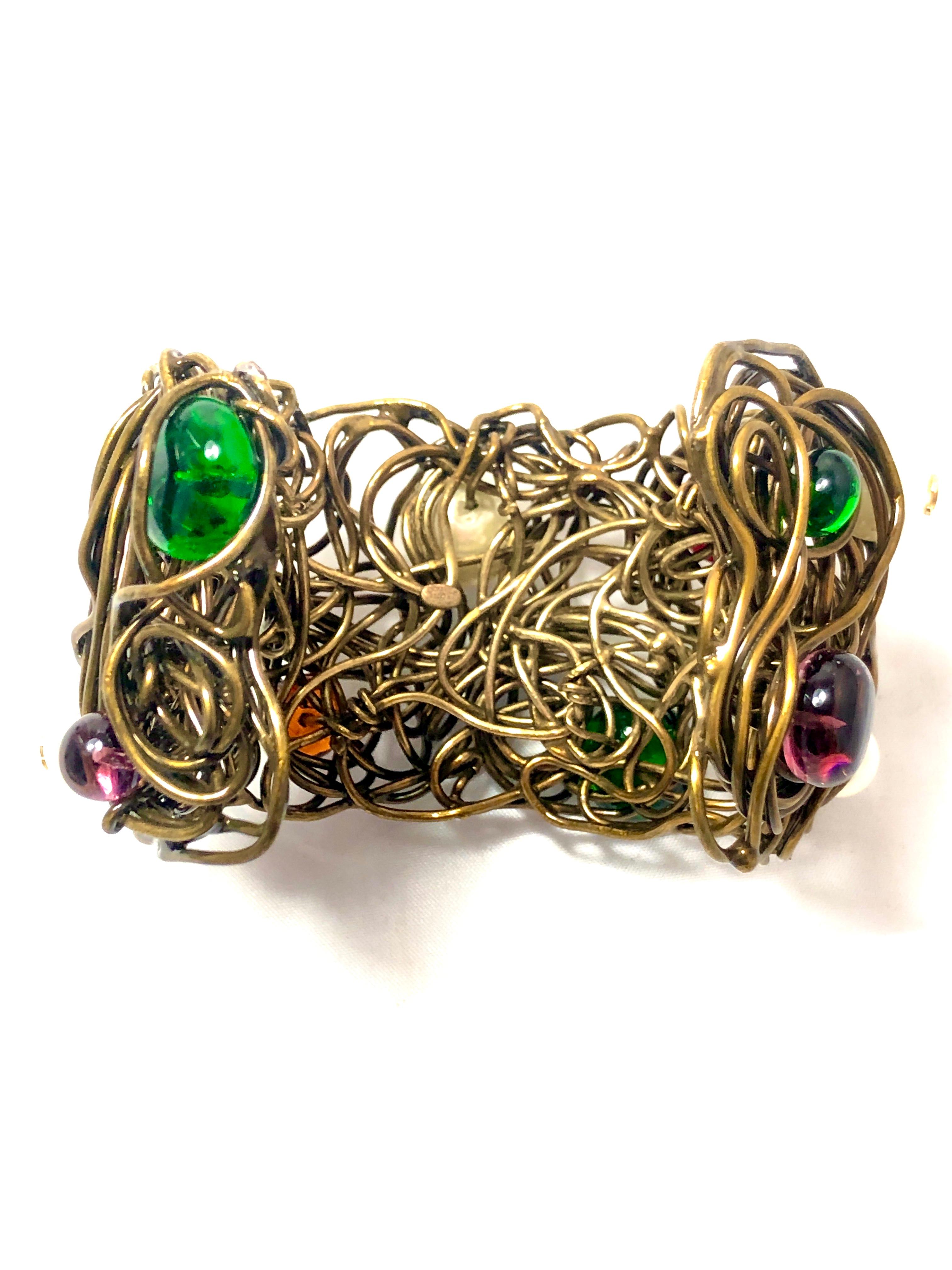 Highly sought after Chanel Bird’s nest Cuff Bracelet.  Adorned with Gripoix glass and pearl Accent.  Dated 1997. This magnificent bracelet is one for the books. Intricate and beautifully crafted, it makes a statement on any wrist. It measures 2