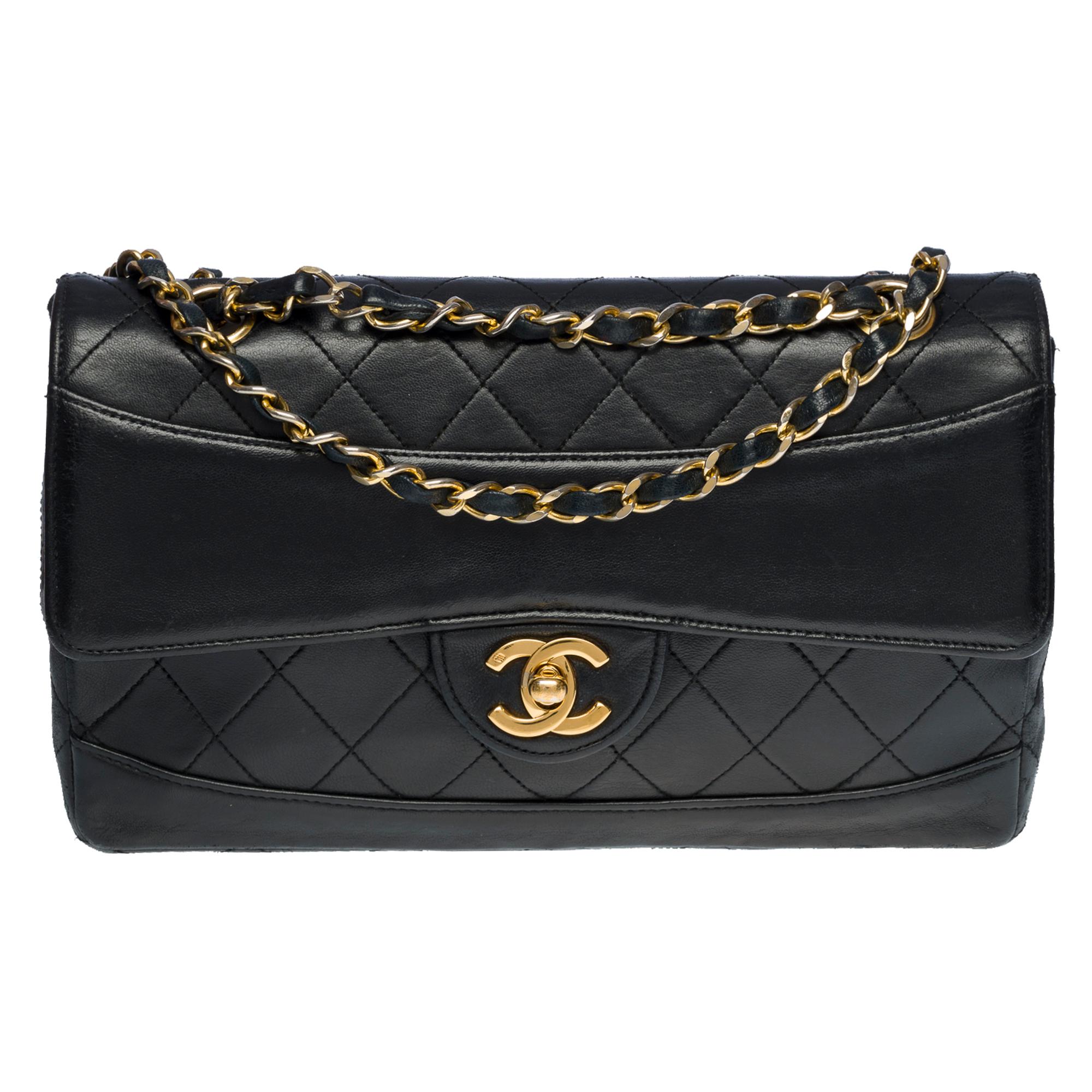 Beautiful Chanel Timeless/Classic 23cm Flap bag in black partially quilted lamb leather, gold-plated metal hardware, a gold-plated metal chain handle interwoven with black leather for a shoulder and shoulder strap, a detachable black quilted leather