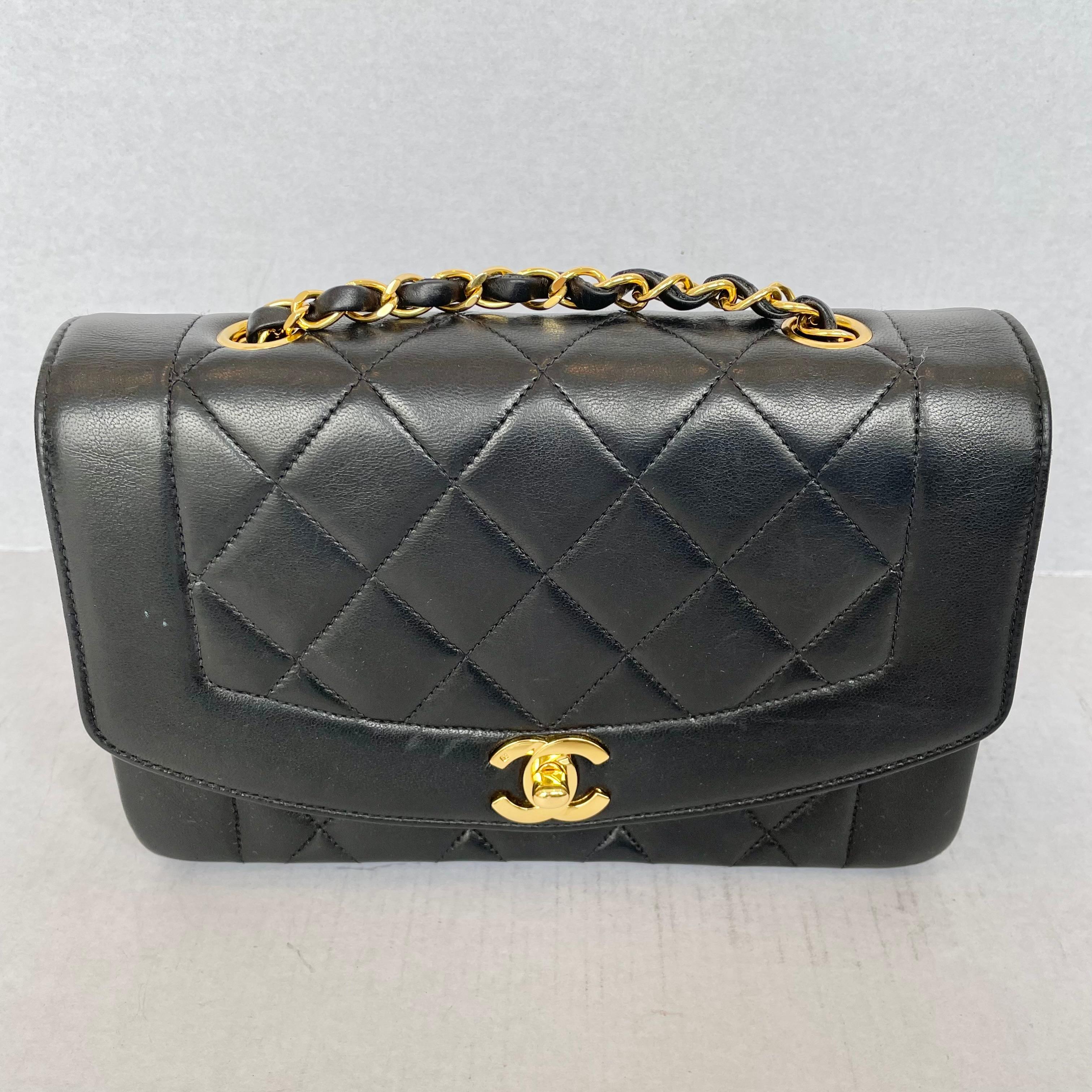 Classic Chanel Diana purse in a stunning black lambskin. This iconic bag features a quilted body with a bare trim around front flap to accentuate the quilted design on the rest of the body as well as the gold tone front clasp of the interlocking
