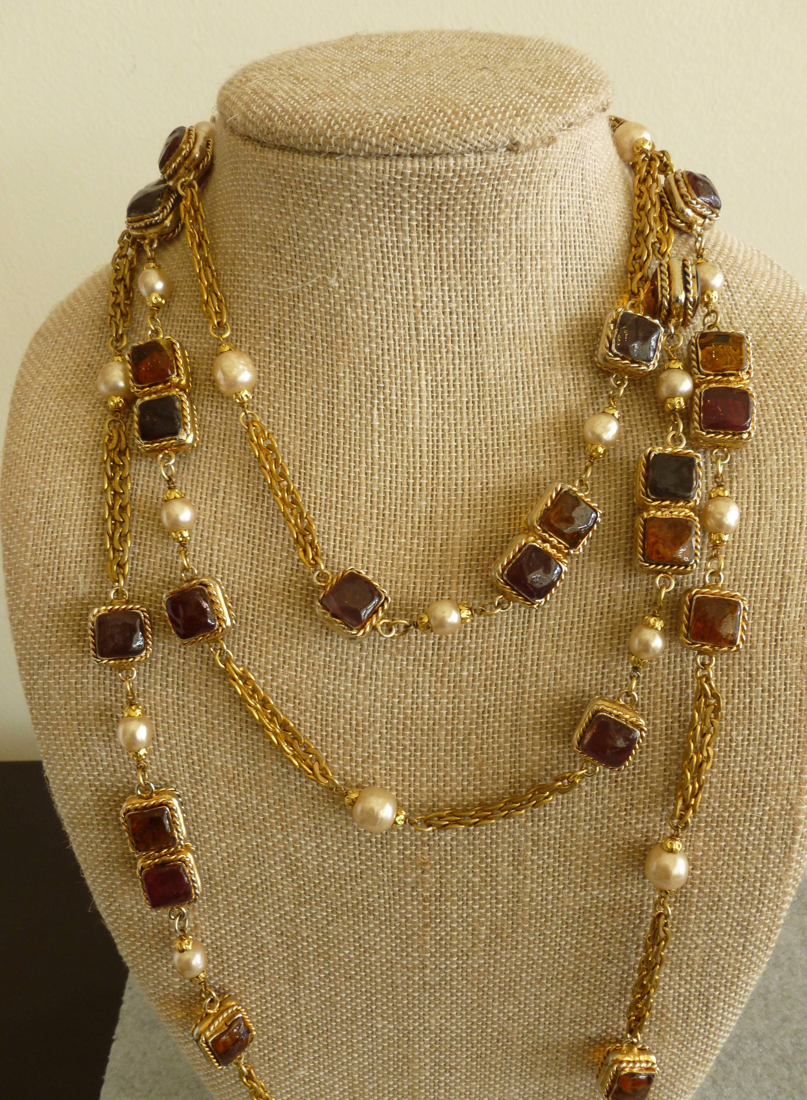 This exceptional and very rare hallmarked Chanel early necklace is gripoix glass, faux pearl, and gold chain link rope. The double chin links are two rows in-between the glass and  faux pearl. Interspersed are clear glass round gripoix glass.  It is