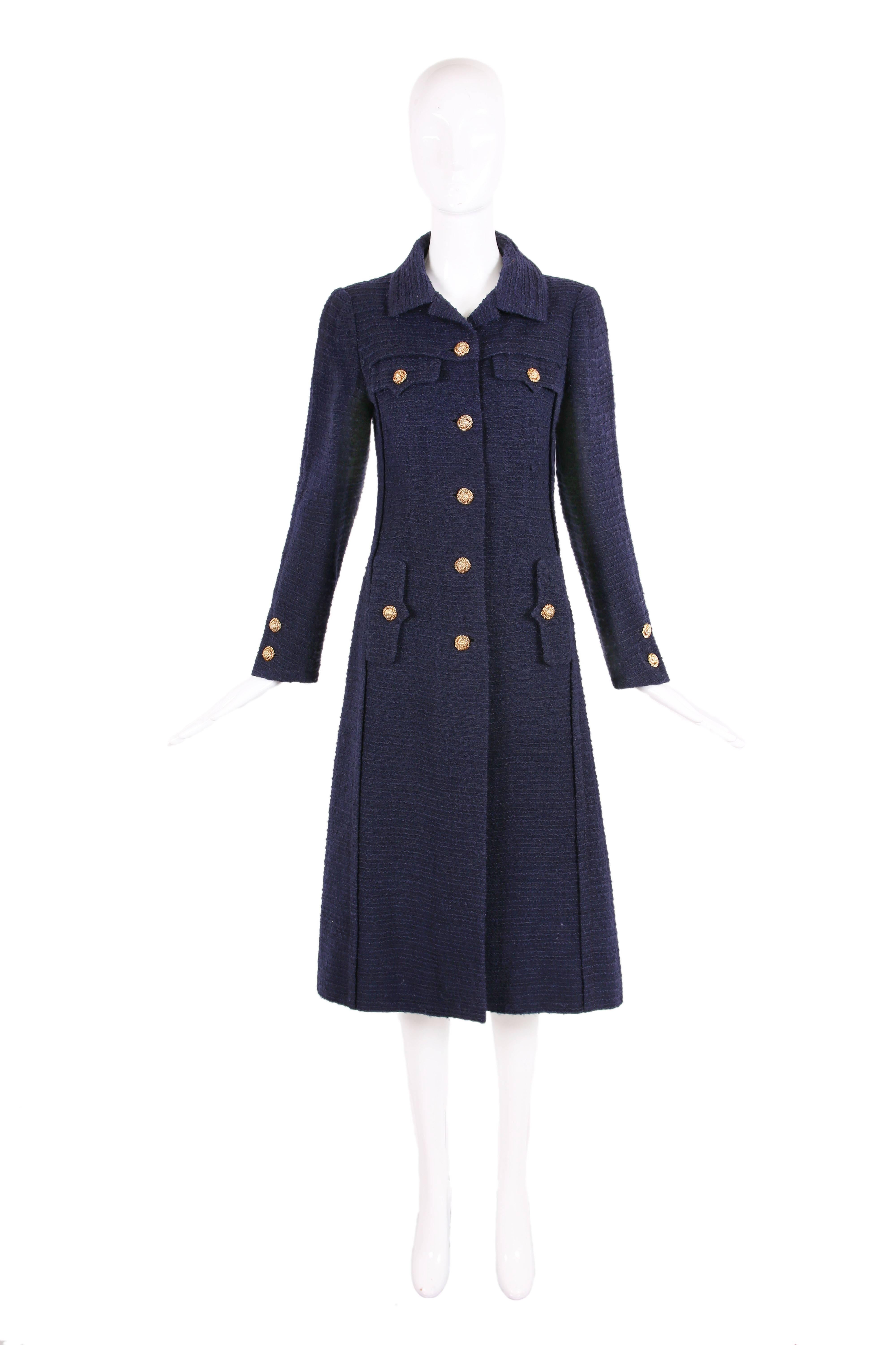 Rare Chanel haute couture navy blue wool boucle coat with round gold-toned buttons featuring a central lion head, No. 55591. Lined w/navy silk at the interior. In excellent condition - made to measure so please consult measurements. This coat should