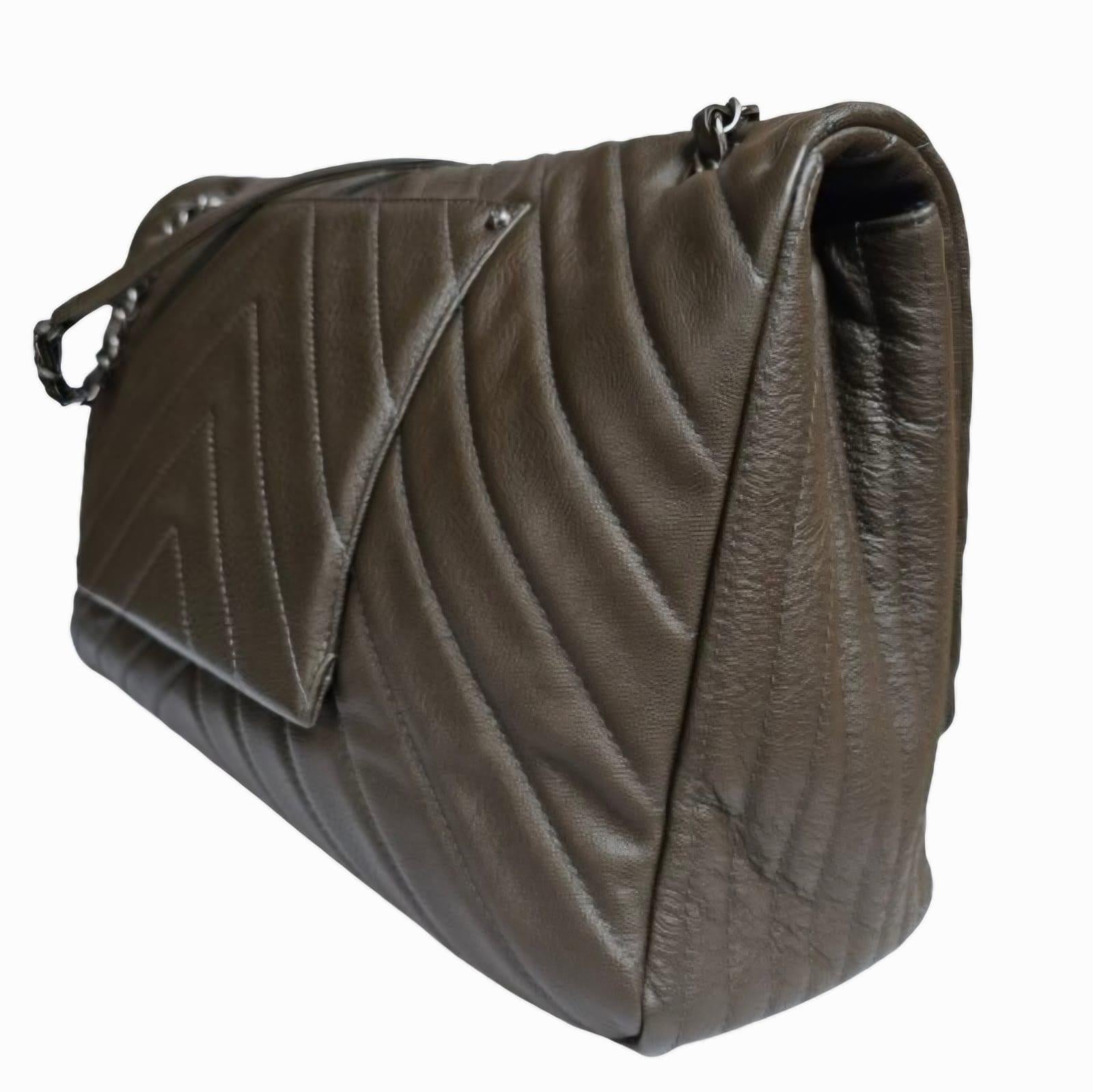Rare Chanel XXL Flap Bag in khaki chevron leather. Overall in very good condition with light suppling due to the shape. Series #23. Comes with its holo and dust bag only.