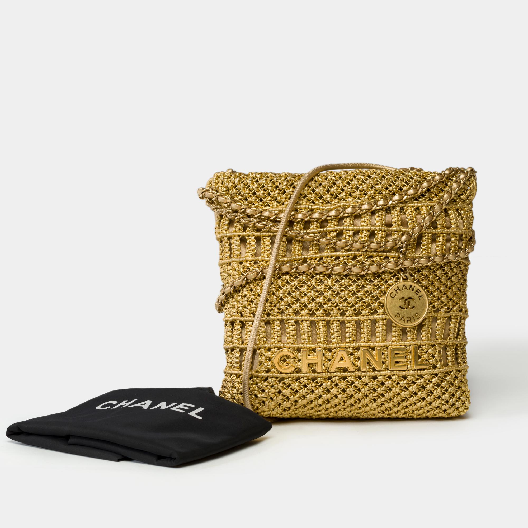 Exceptional​ ​&​ ​Extremely​ ​Rare​ ​limited​ ​edition​ ​Chanel​ ​Mini​ ​22​ ​Métiers​ ​d'Art​ ​crossbody​ ​bag​ ​in​ ​metallic​ ​gold​ ​macramé​ ​calfskin​ ​leather.​ ​It​ ​features​ ​a​ ​short​ ​gold-tone​ ​metal​ ​handle​ ​interlaced​ ​with​