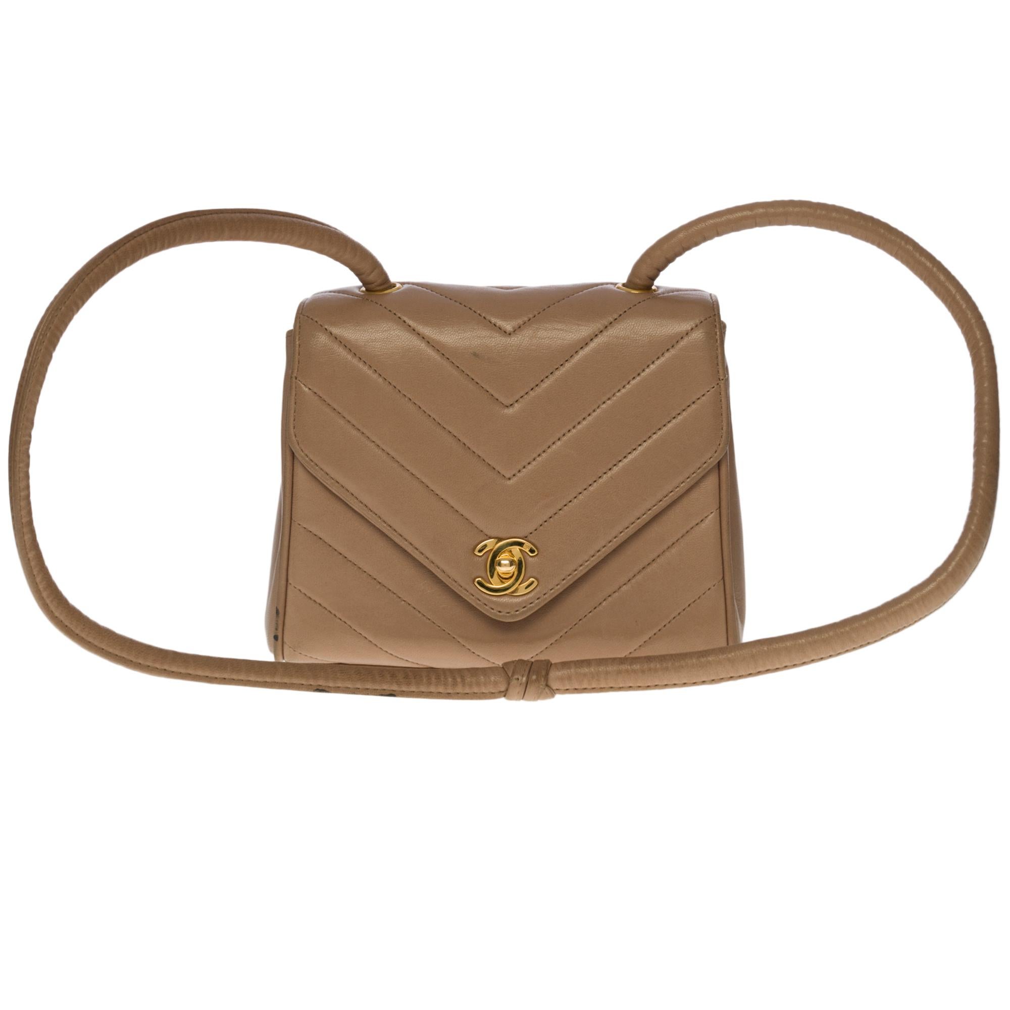 Rare & Charming Chanel Mini Flap bag with herringbone pattern in taupe lambskin leather, gold-tone metal hardware, a tubular taupe leather handle with flange for shoulder and shoulder strap

Backpack pocket
Flap closure, gold CC logo clasp
Mirror