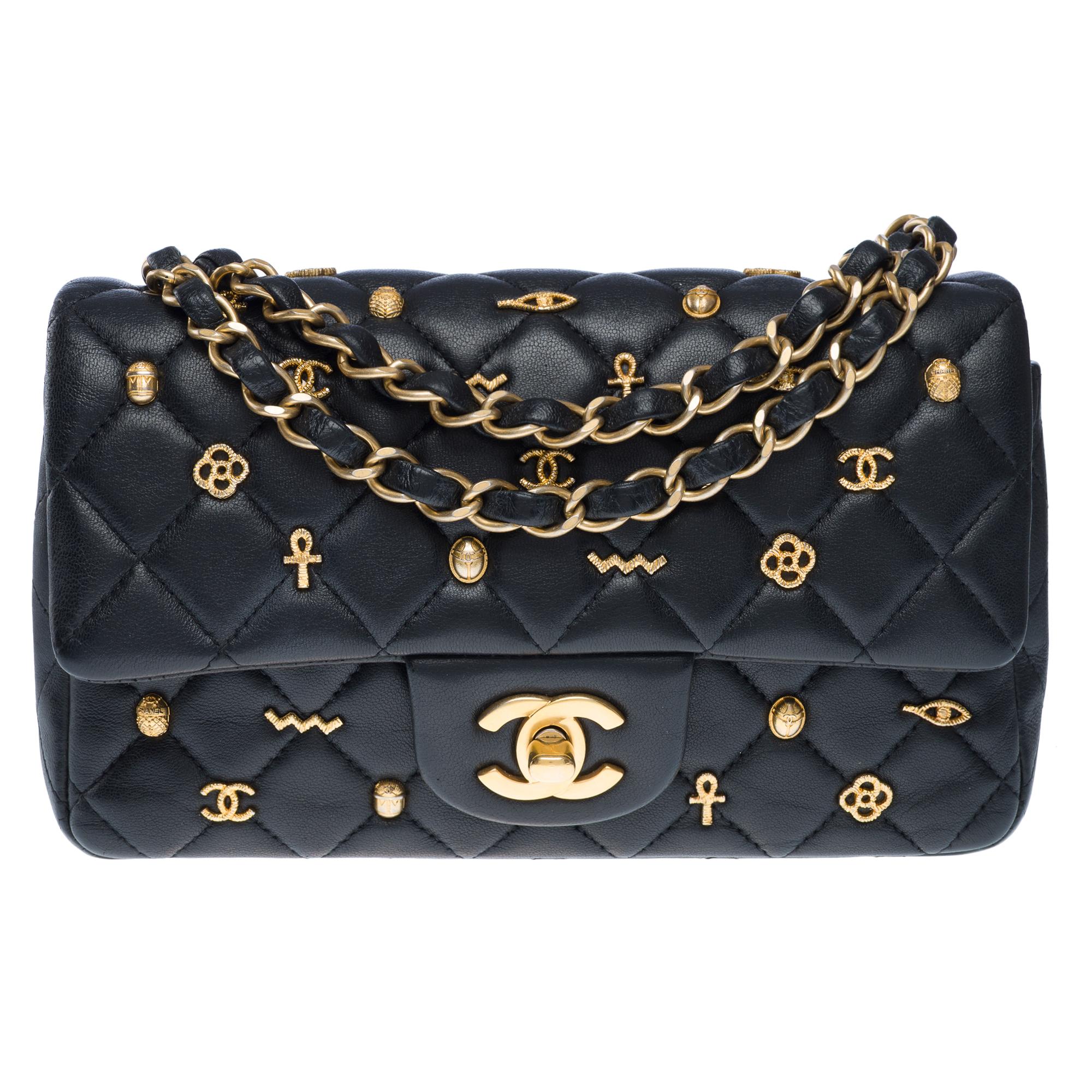Rare​ ​collector's​ ​piece,​ ​this​ ​Chanel​ ​Mini​ ​Rectangular​ ​2019​ ​Egyptian​ ​Amulet​ ​Limited​ ​Edition​ ​Flap​ ​Bag​ ​is​ ​crafted​ ​from​ ​black​ ​lambskin​ ​leather​ ​and​ ​adorned​ ​with​ ​gold​ ​studs​ ​inspired​ ​by​ ​ancient​ ​Egypt.​