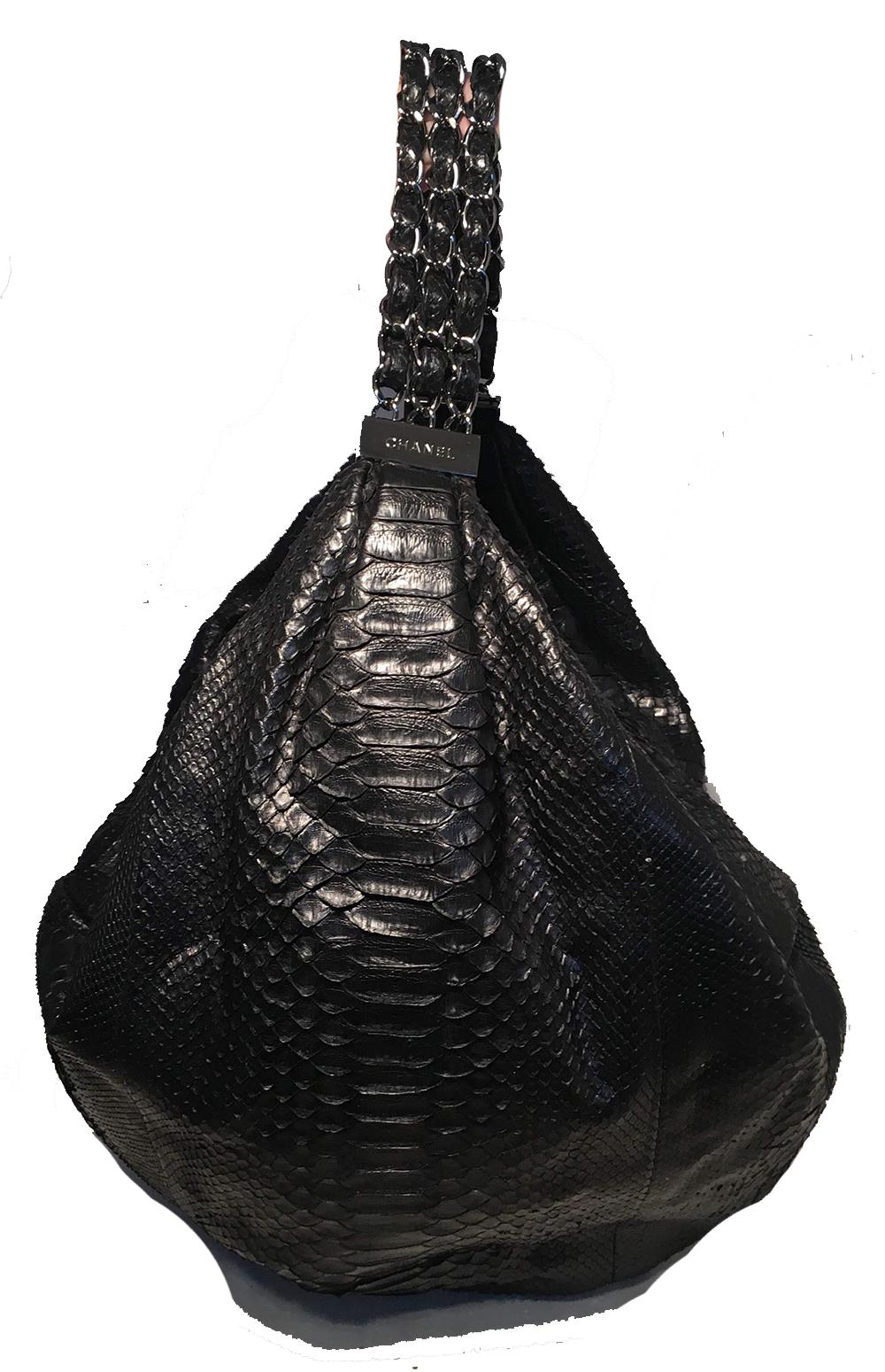 Chanel Runway black python snakeskin hobo shoulder bag in excellent condition. Black python snakeskin exterior trimmed with silver hardware and a triple row of chain and leather woven handle. Top zipper closure opens to a grey satin lined interior