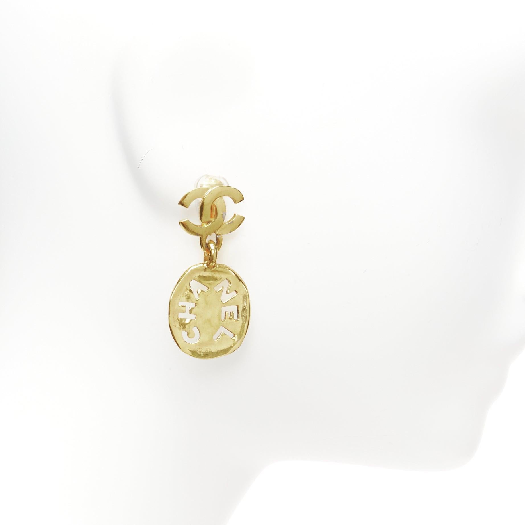 rare CHANEL Vintage gold CC logo cut out hammered coin clip on earrings In Good Condition For Sale In Hong Kong, NT