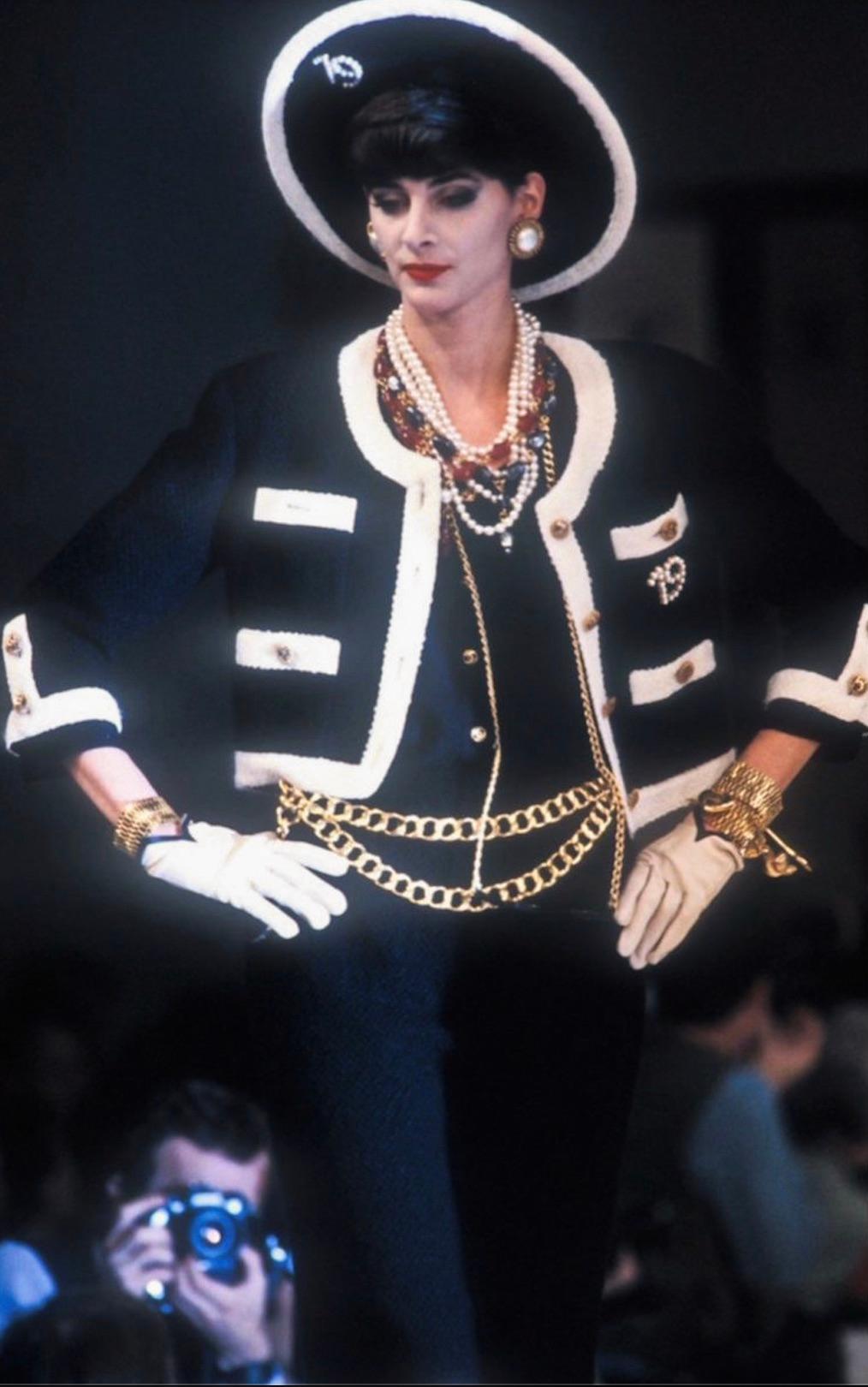 This rare and collectible piece is a Chanel Spring/Summer 1983 jacket, part of the first ready-to-wear collection by Karl Lagerfeld for the iconic fashion house. Crafted from luxurious black and white tweed, it embodies the timeless elegance and