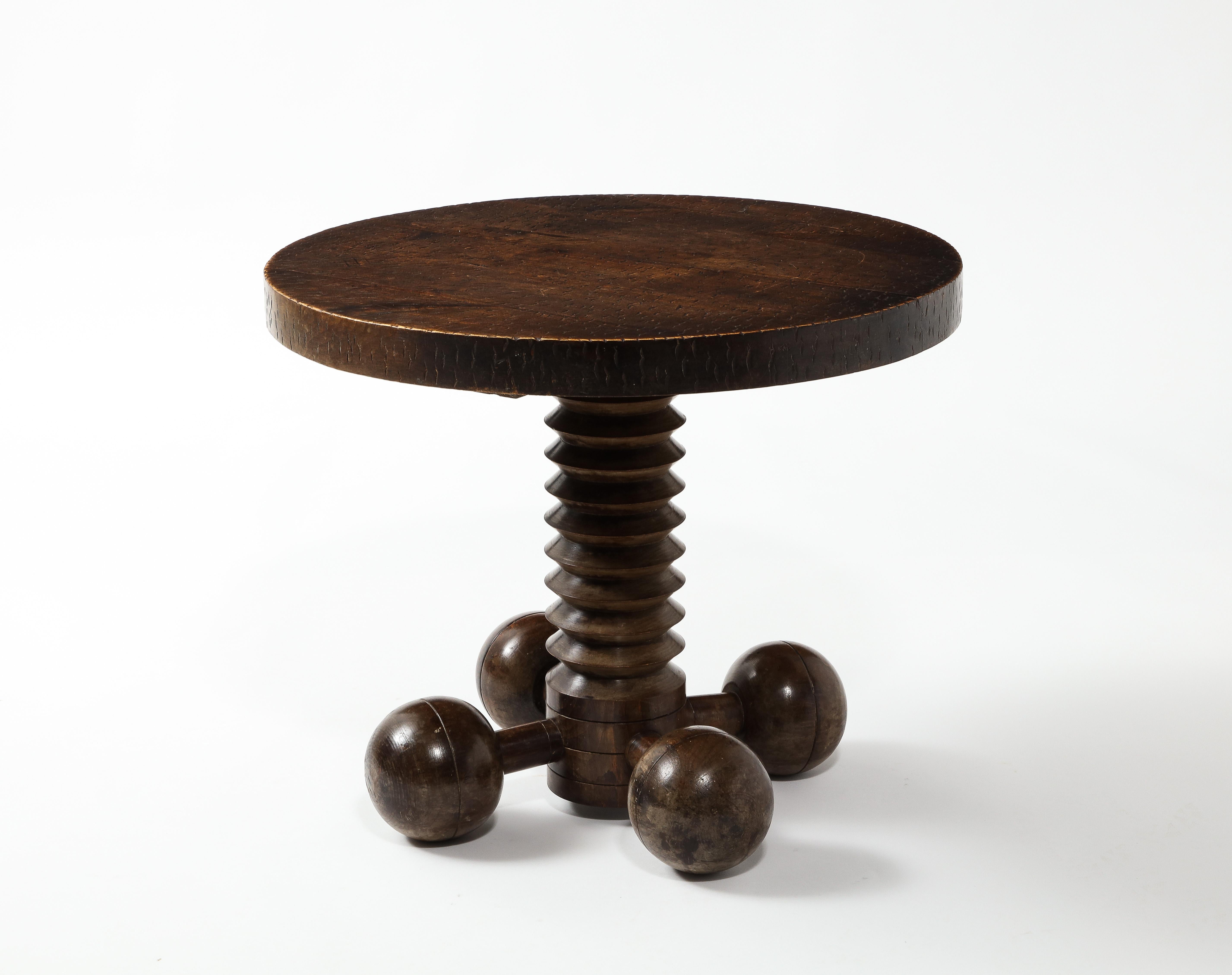 A very unusual variation of this well-known design by Dudouyt, this table has four spheres supporting it versus the usual three. A rare find.