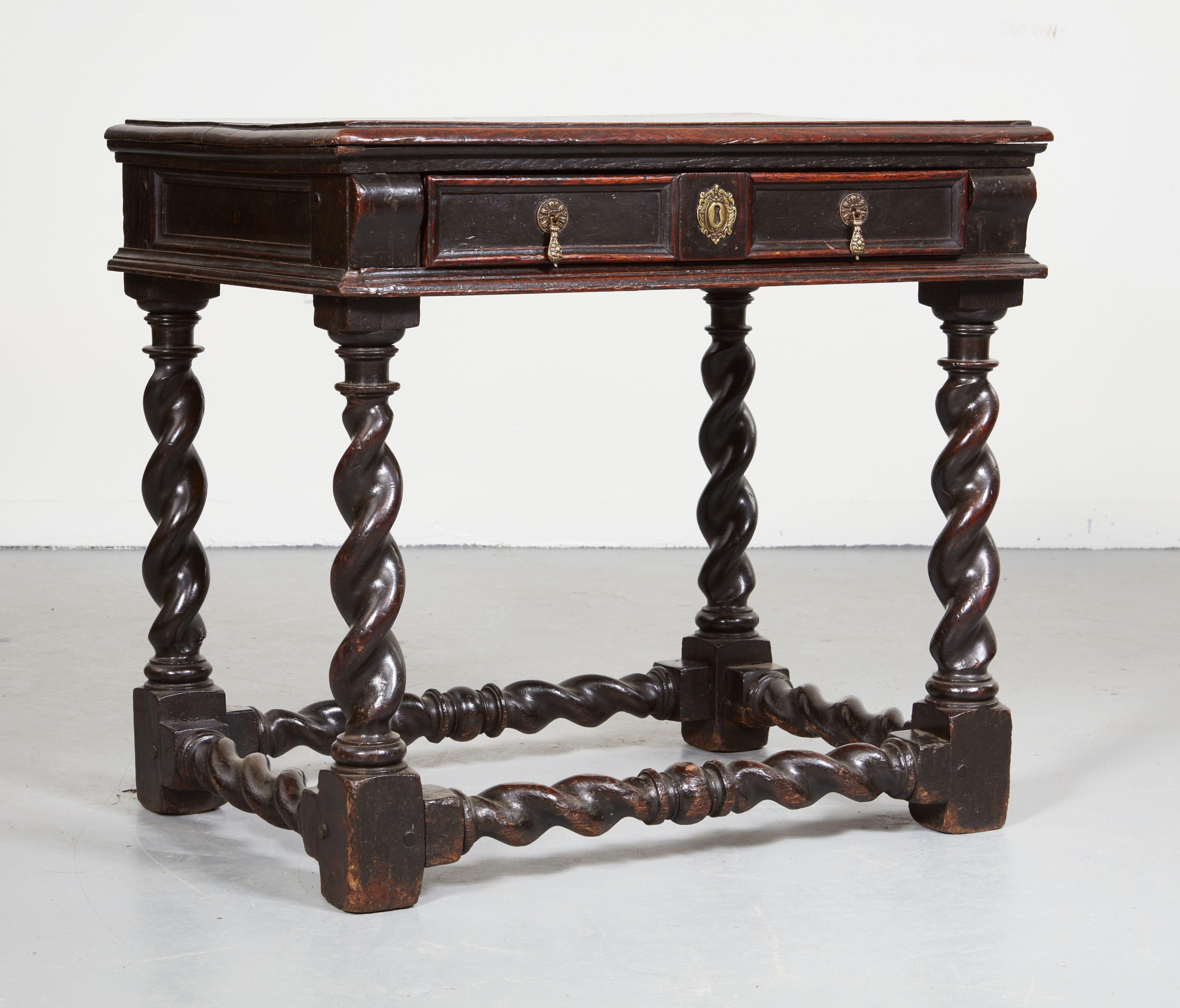 A rare and exceptional Charles II single drawer side table. In glowing dark oak with barley twist legs of substantial heft and conforming box stretcher, having rectangular molded two plank top over molded front and sides with single molded drawer