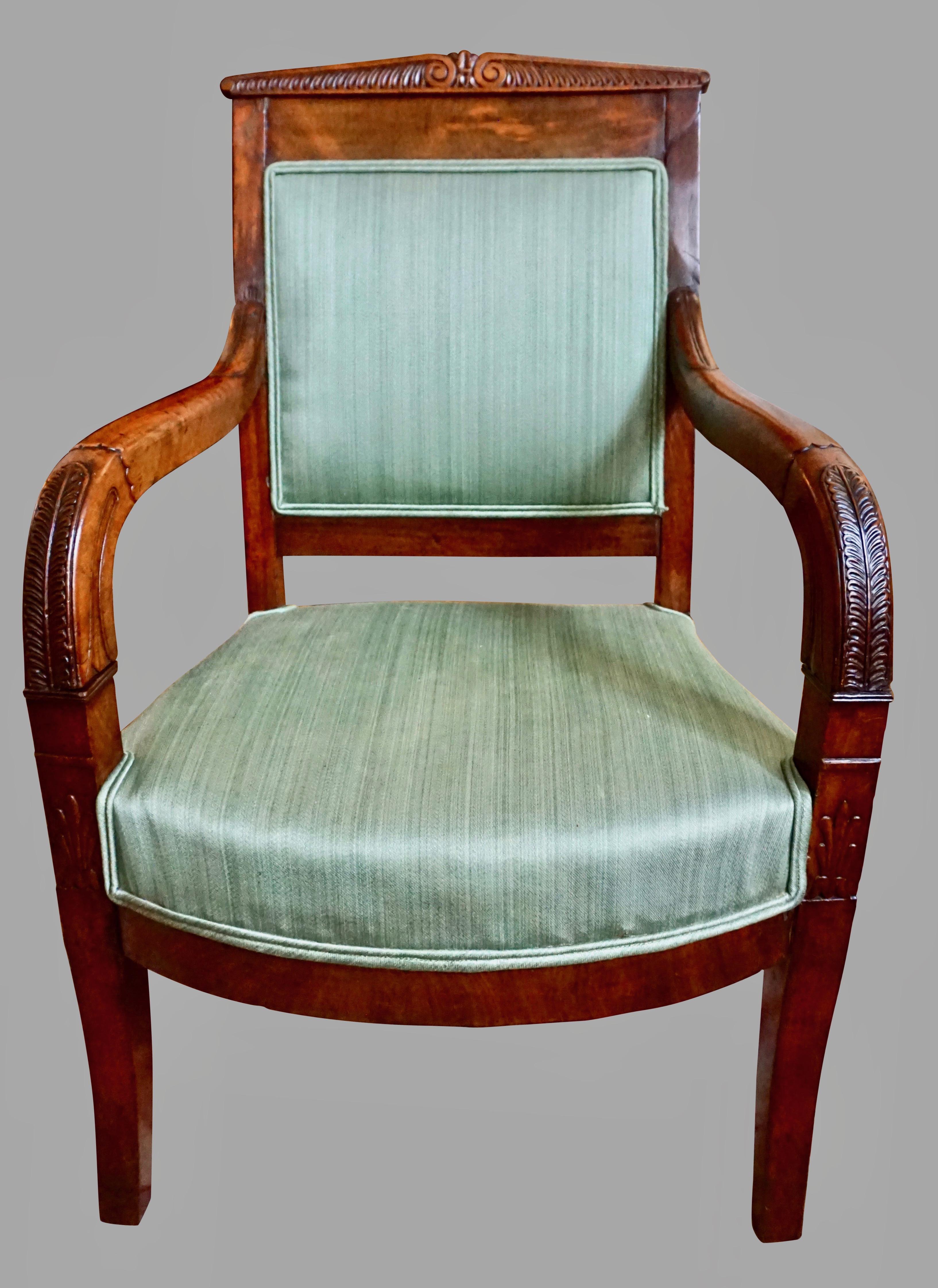 A rare and charming French Charles X period mahogany child's armchair, the carved triangular crest rail above downswept arms with acanthus leaf details, all resting on curved legs. Now upholstered in a vintage green striped fabric. Old repairs.