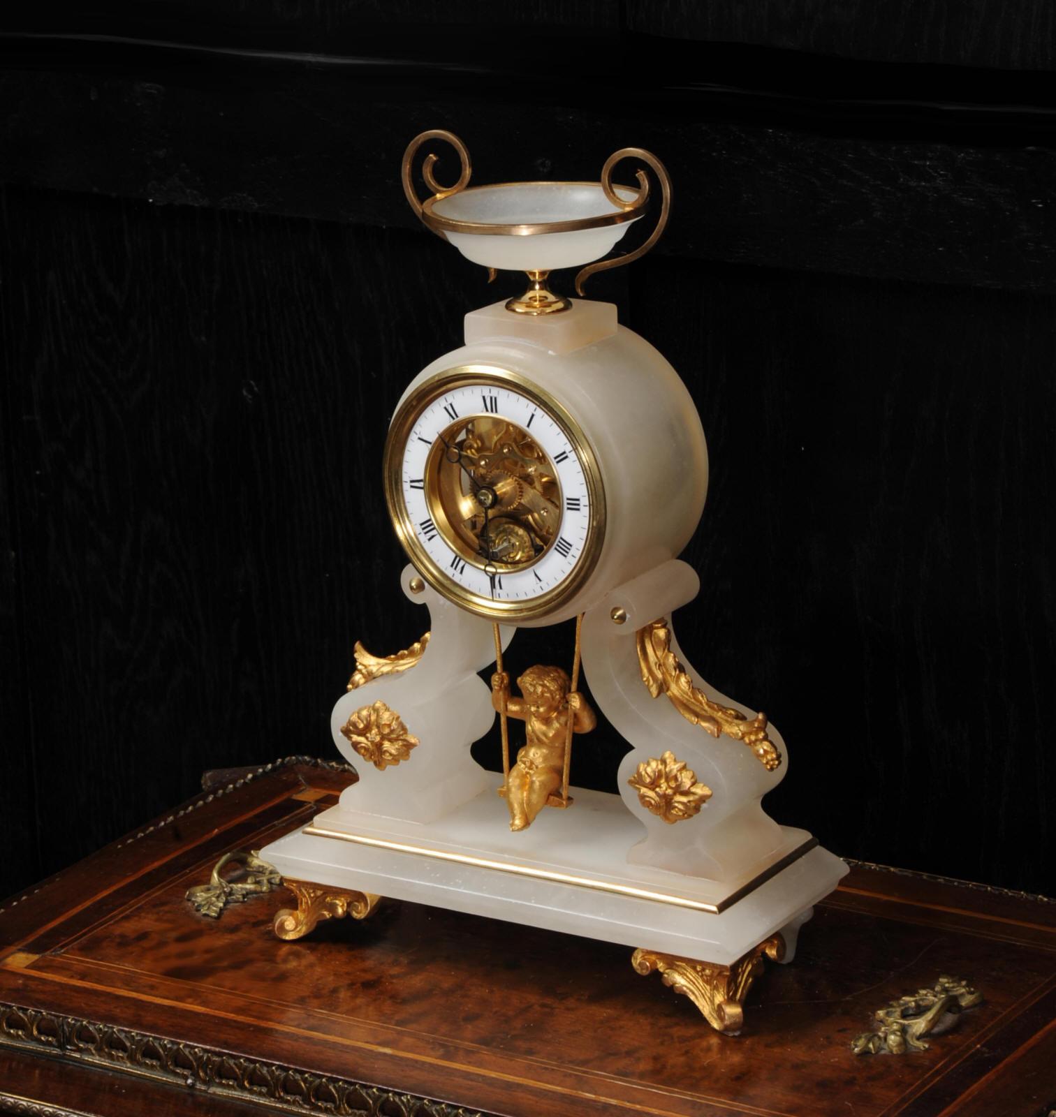 A super, rare original antique French clock featuring a cherub swinging back and forth as the pendulum, circa 1870. It uses a single escape wheel with pin-pallets acting at 90 degrees to achieve the back and forth swing. The beauty of this design is
