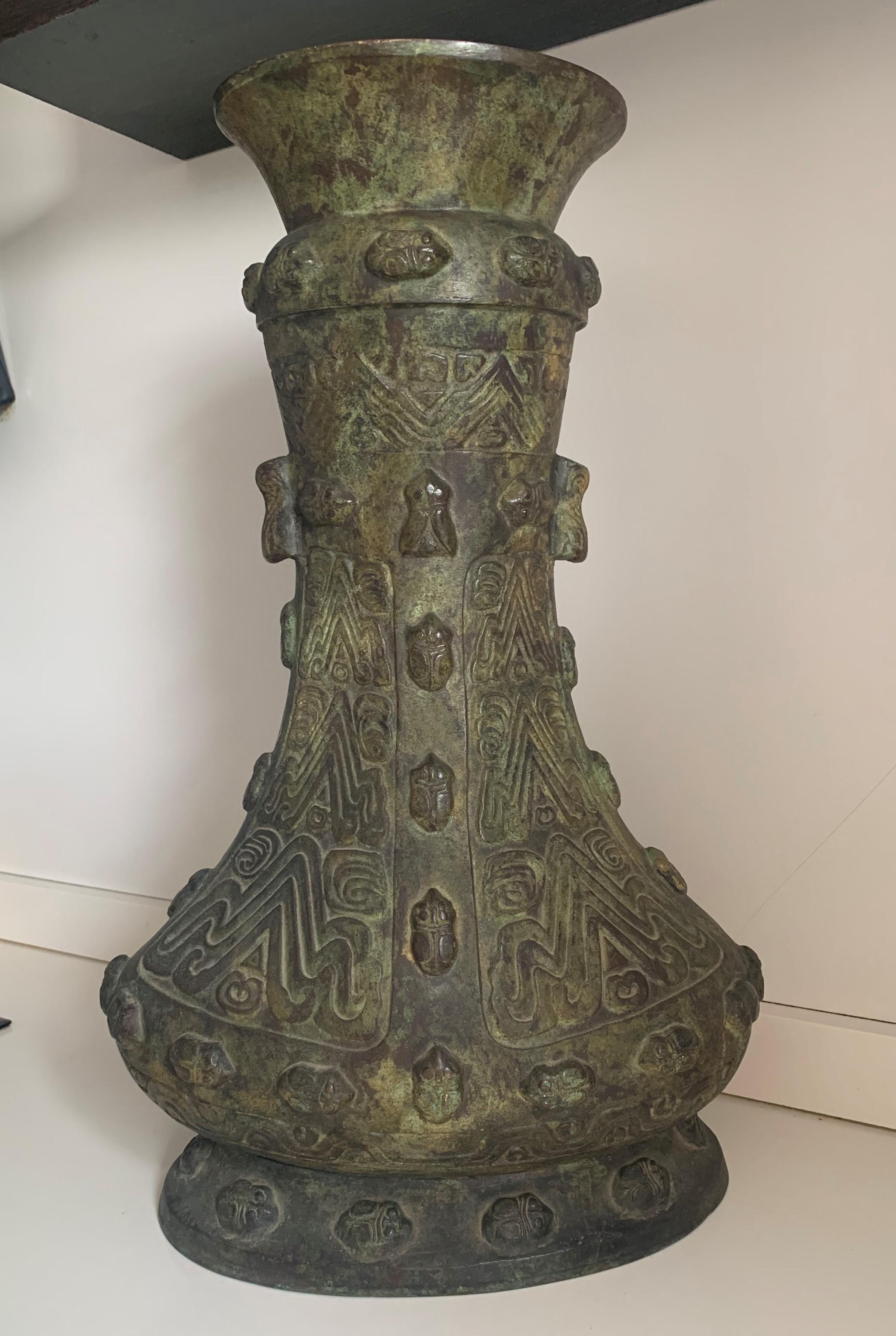 Of Classic vessel form, with an oval, splayed foot, narrow, waisted body and wide, flaring mouth.
Very heavy and archaist vessel with lucky beetles around the sides.
   